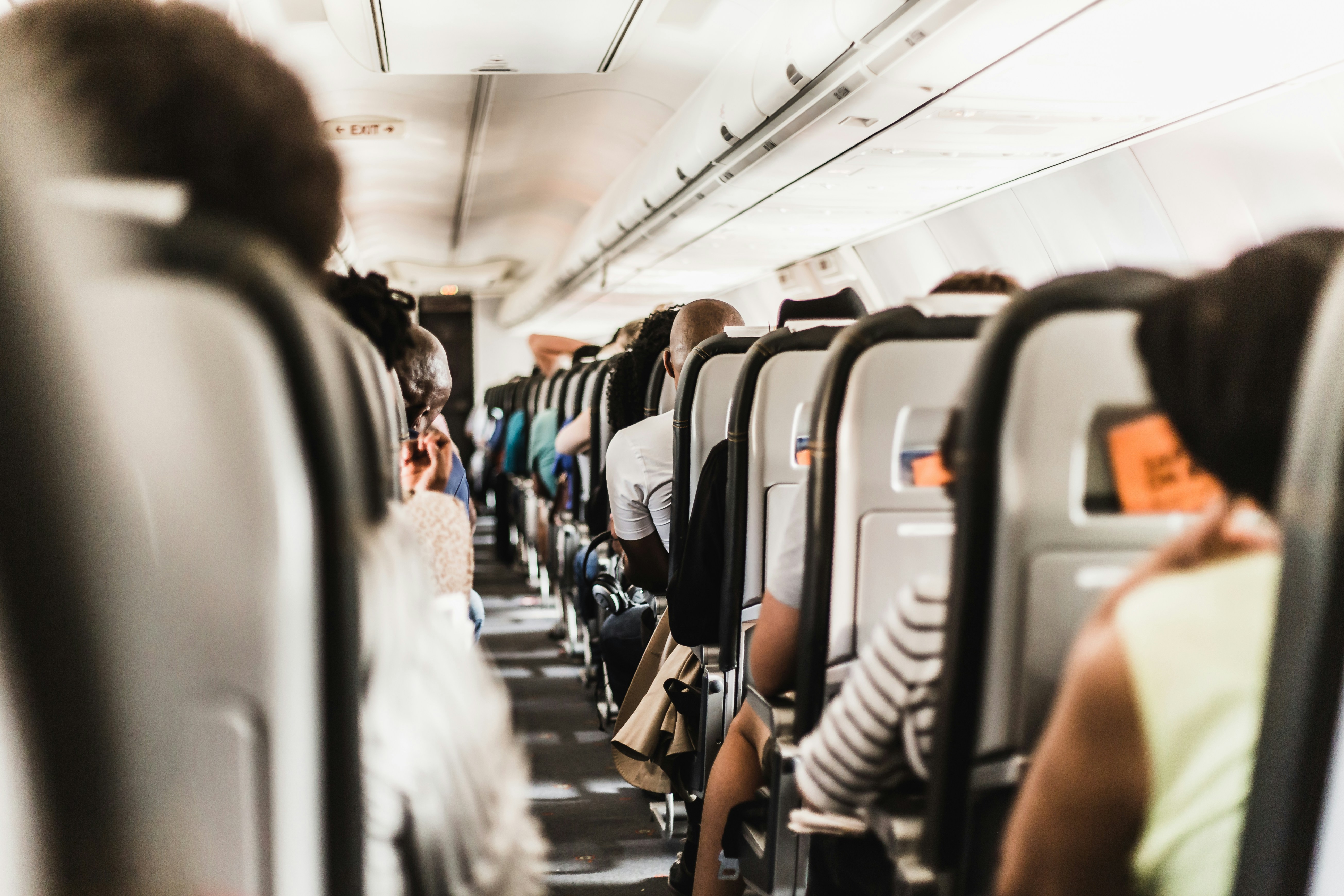Passengers seated inside an airplane cabin during flight