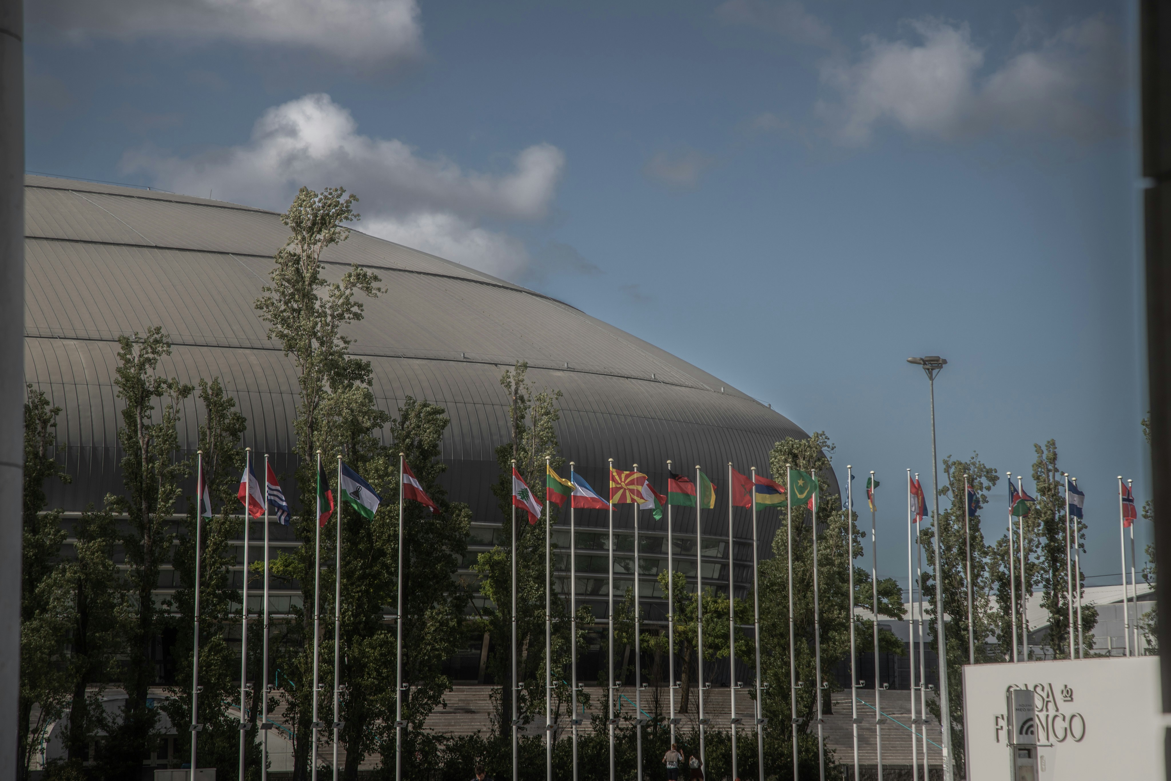 Stadium with multiple international flags in front