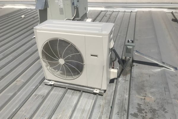Outdoor HVAC unit installed on a metal rooftop