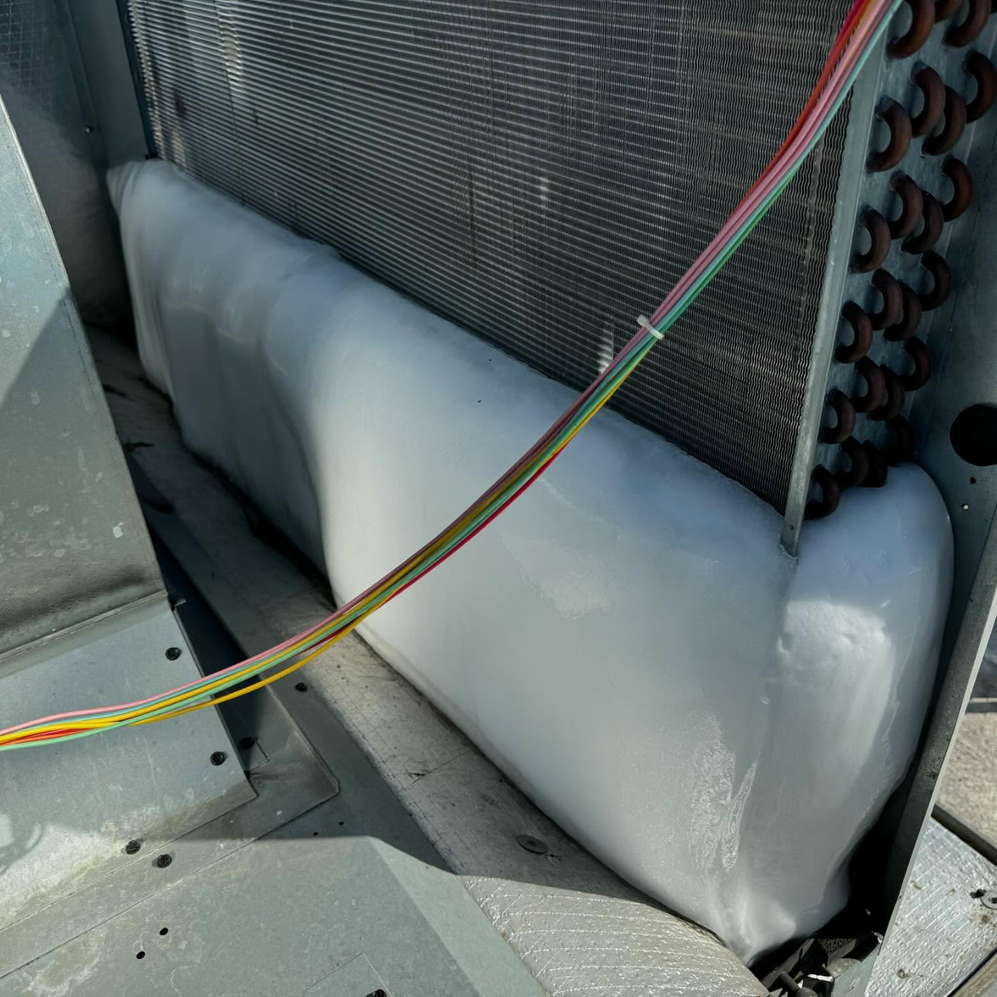 Frozen evaporator coil in an HVAC unit indicating potential malfunction