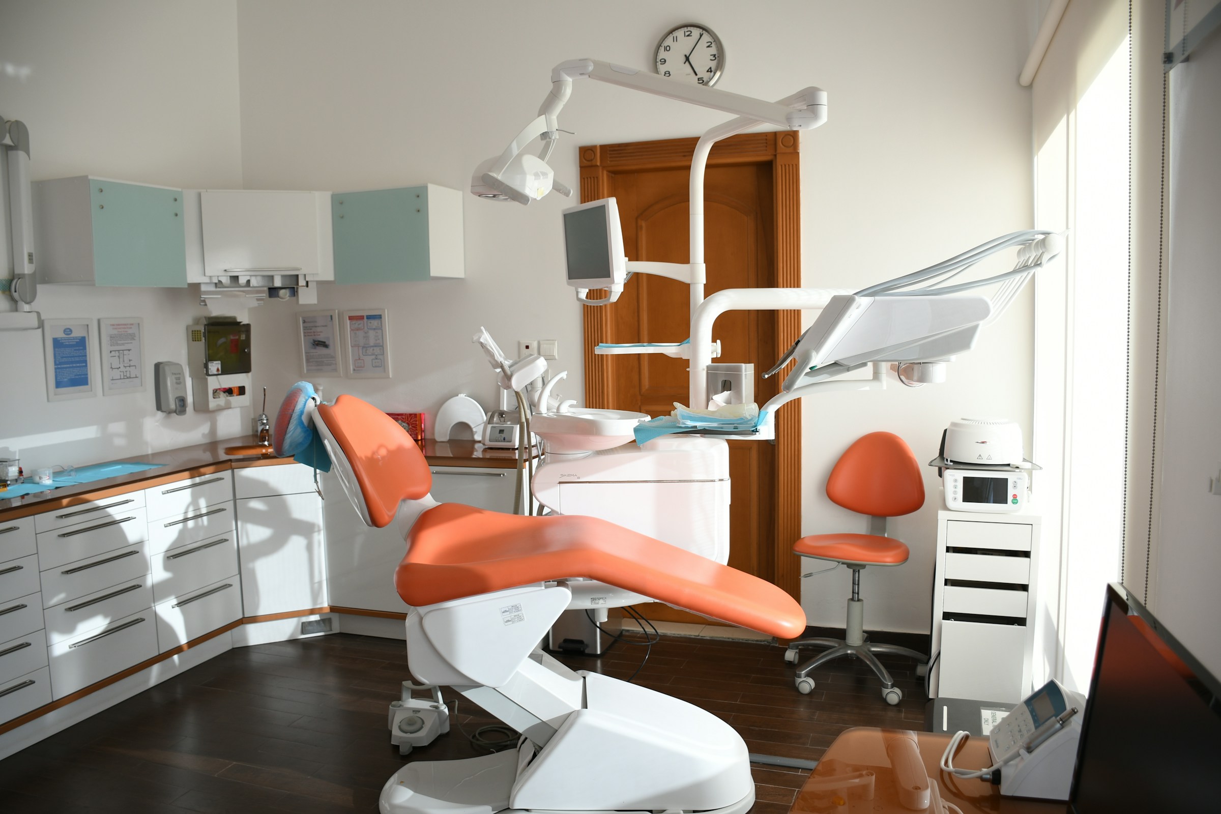 Doctor presenting to a team of colleagues in a bright conference room