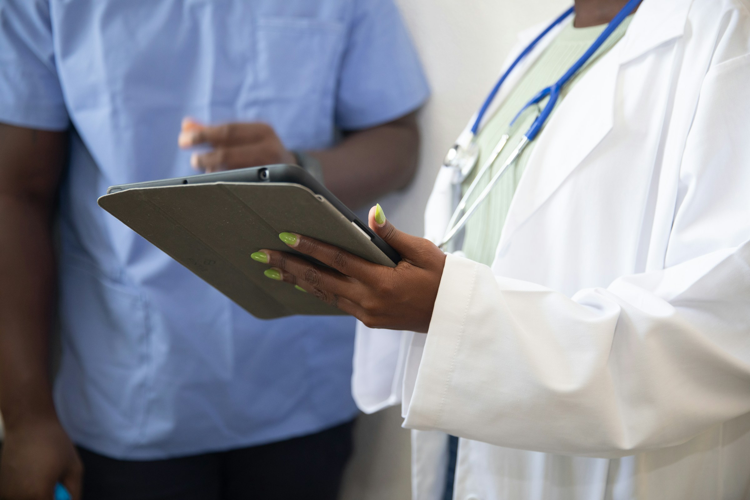 Doctor presenting to a team of colleagues in a bright conference room