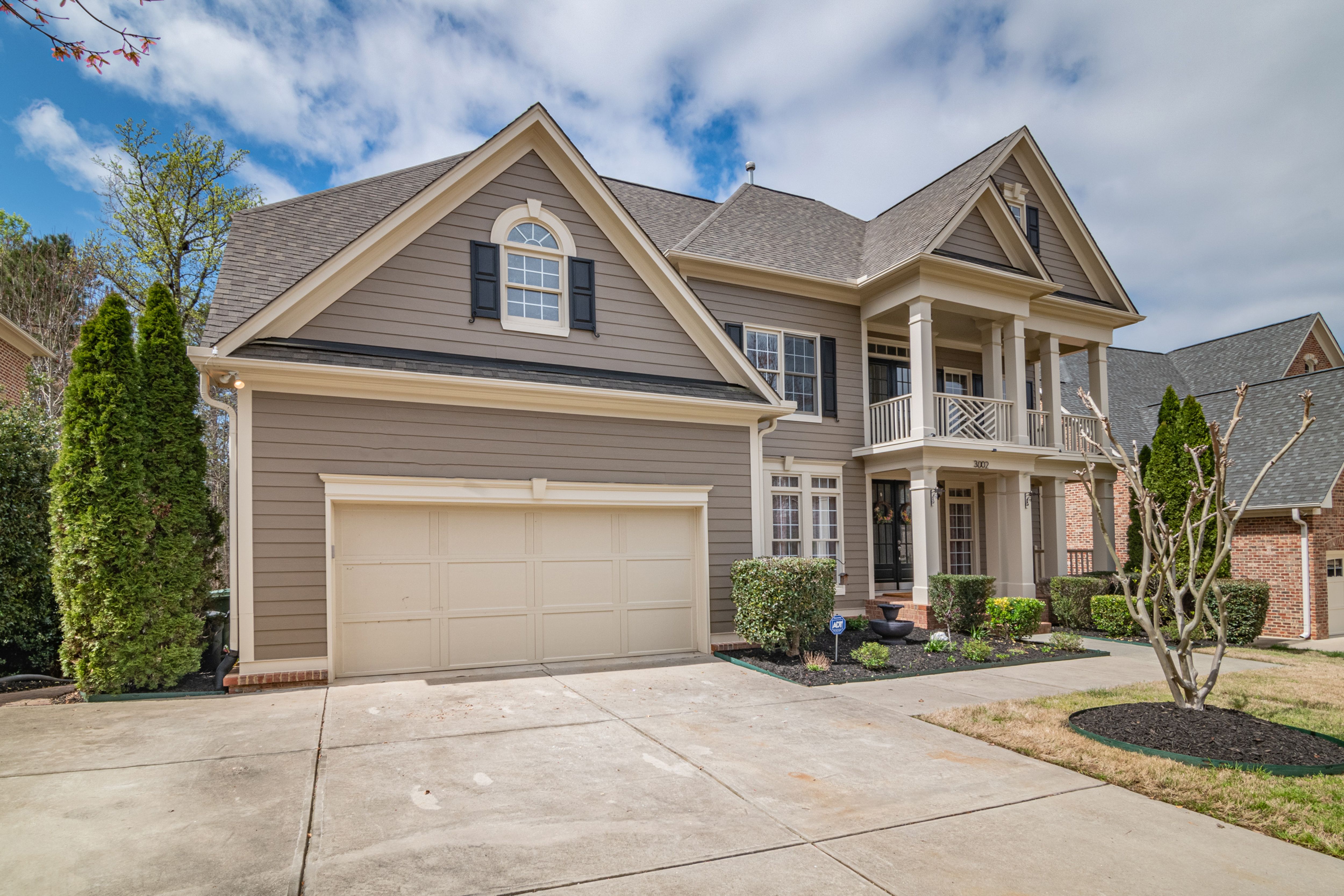 Two-story suburban home with a double garage and landscaped front yard