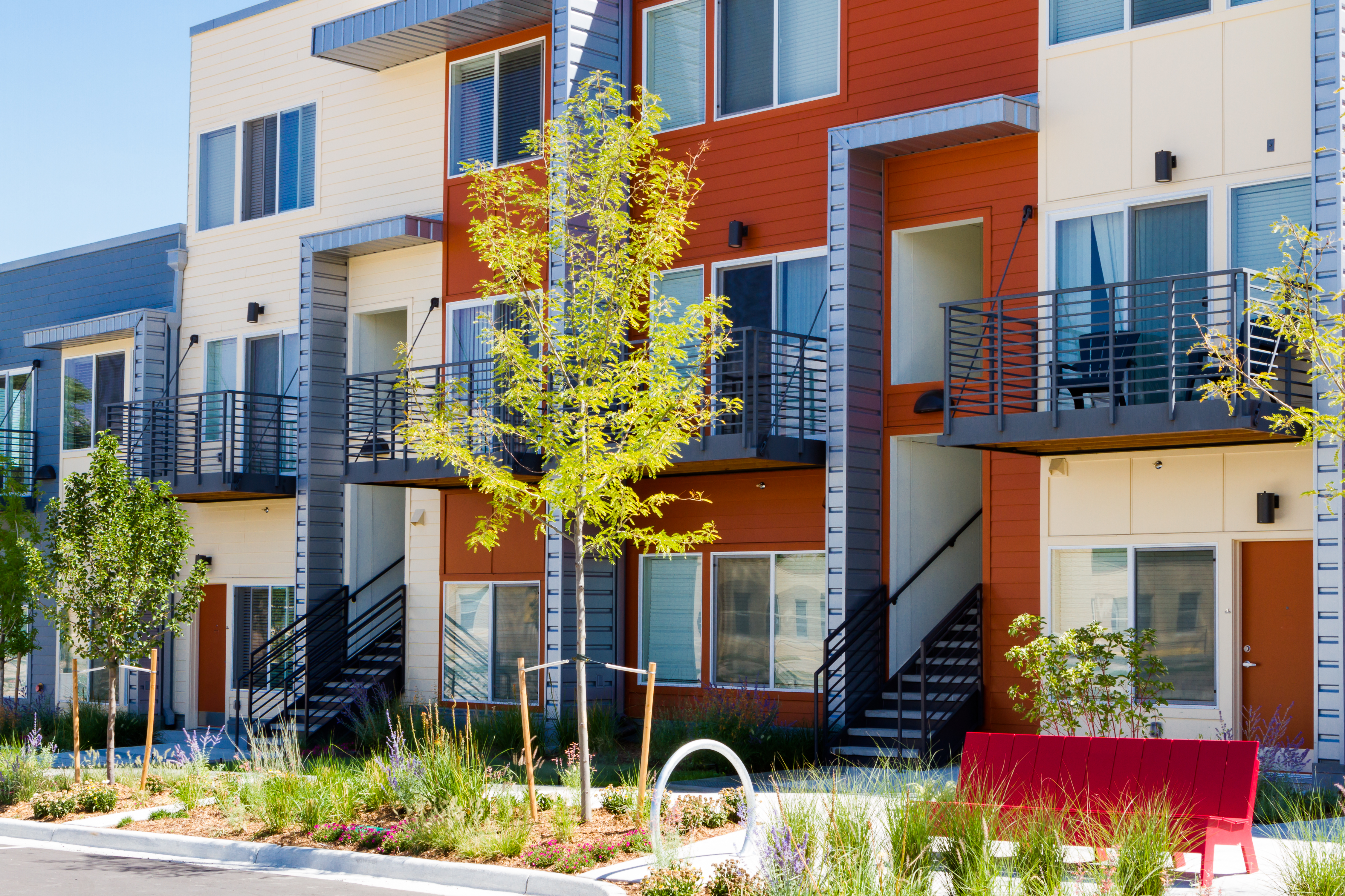 Modern multi-story apartment building with colorful facades and balconies