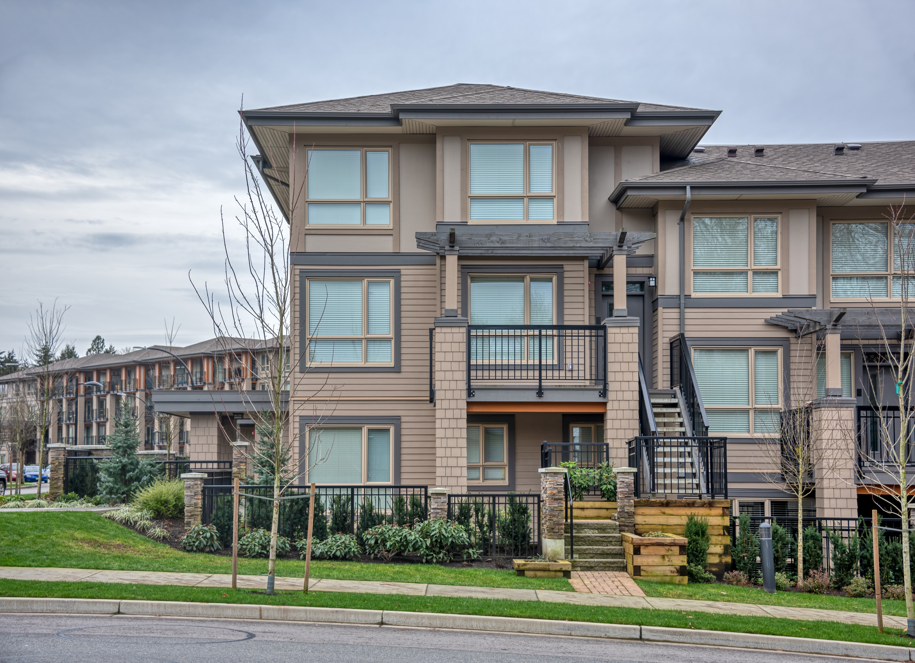 Modern multi-story residential building with landscaped surroundings