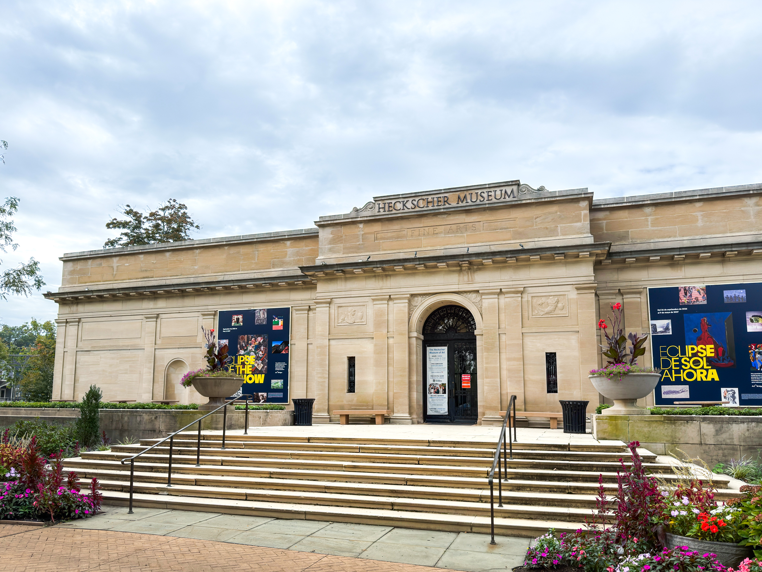Front view of Heckscher Museum with posters and steps leading to entrance