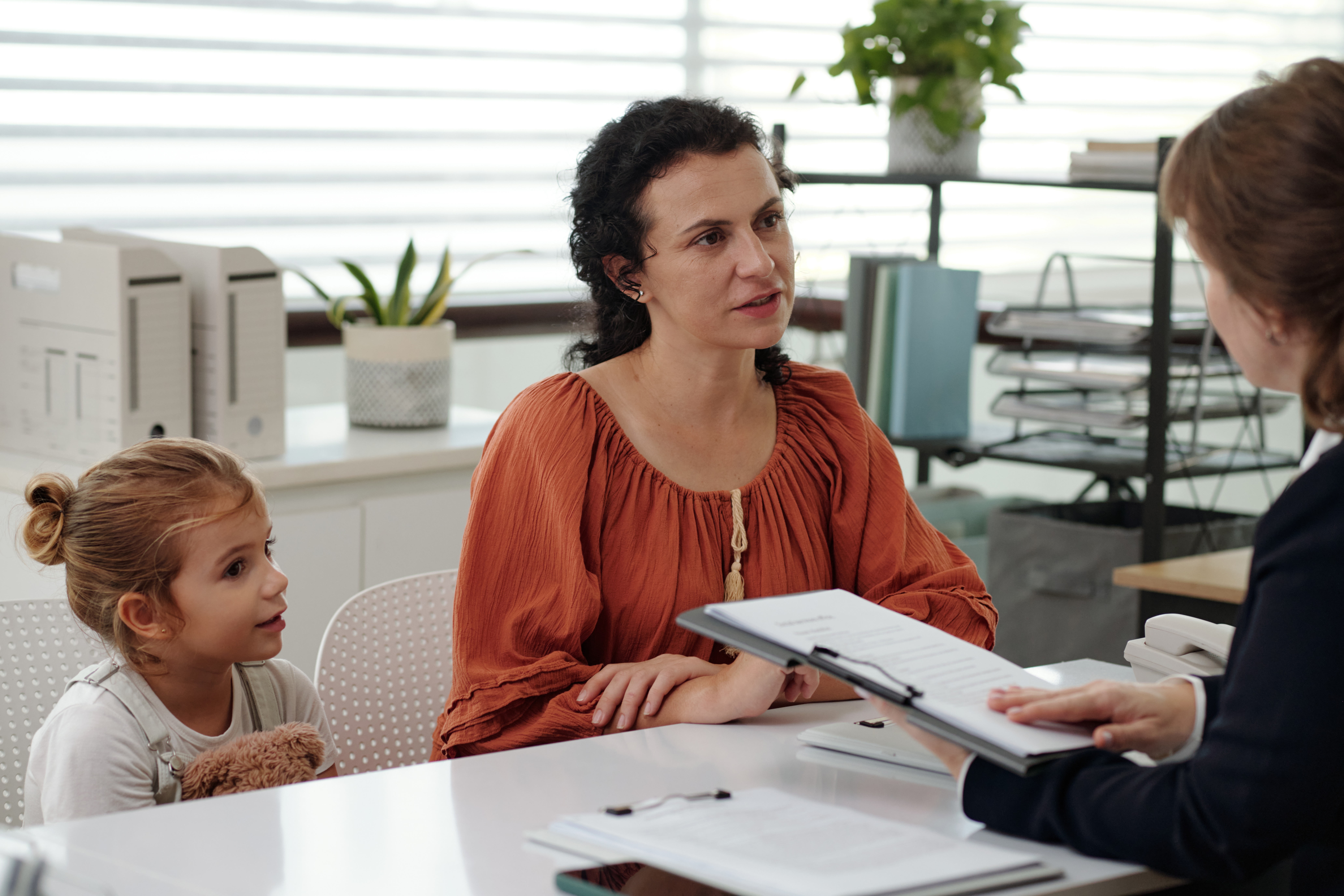 Woman and child consulting with a professional in an office setting