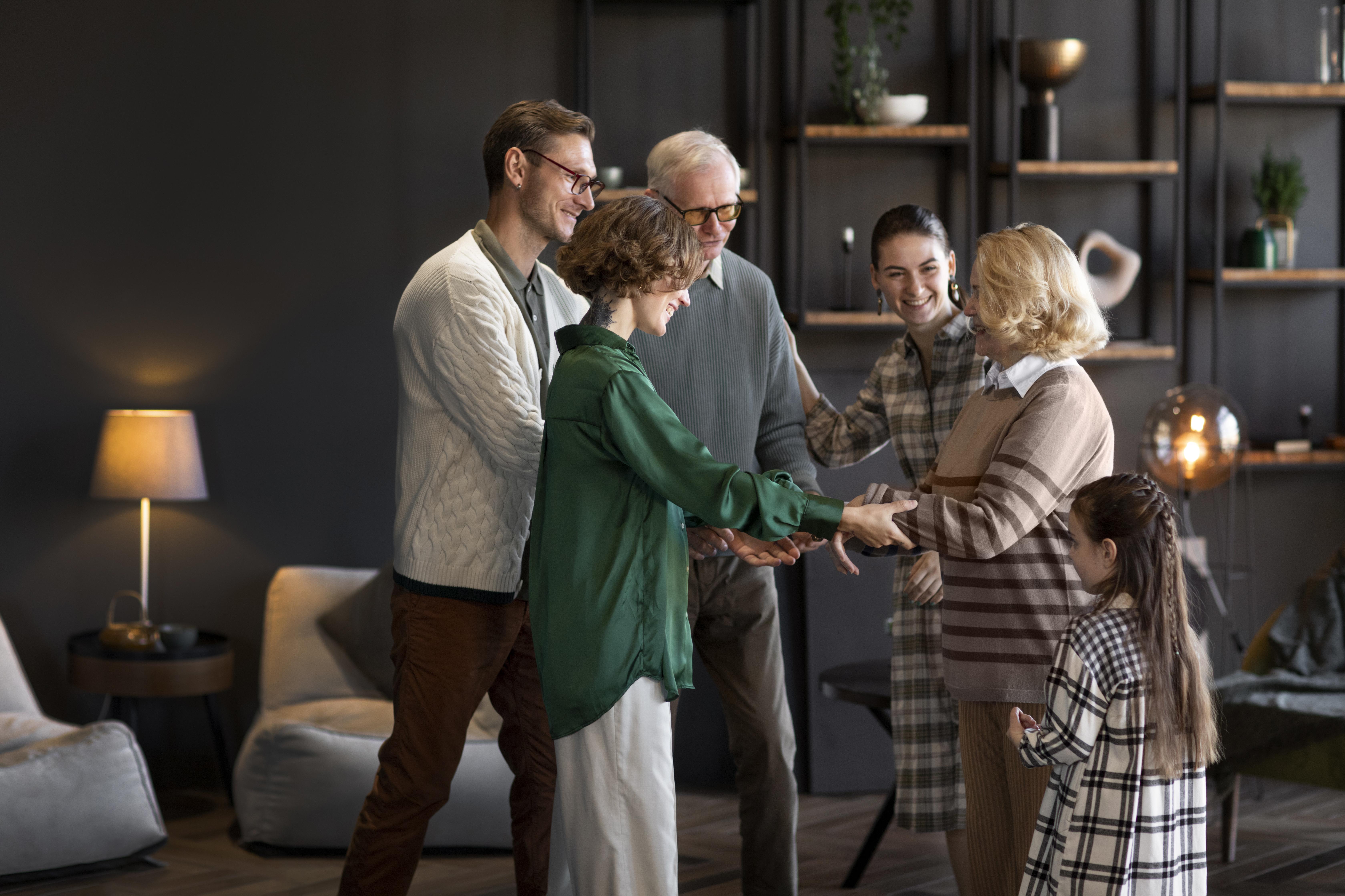 Family members of different generations greeting each other warmly in a cozy living room.