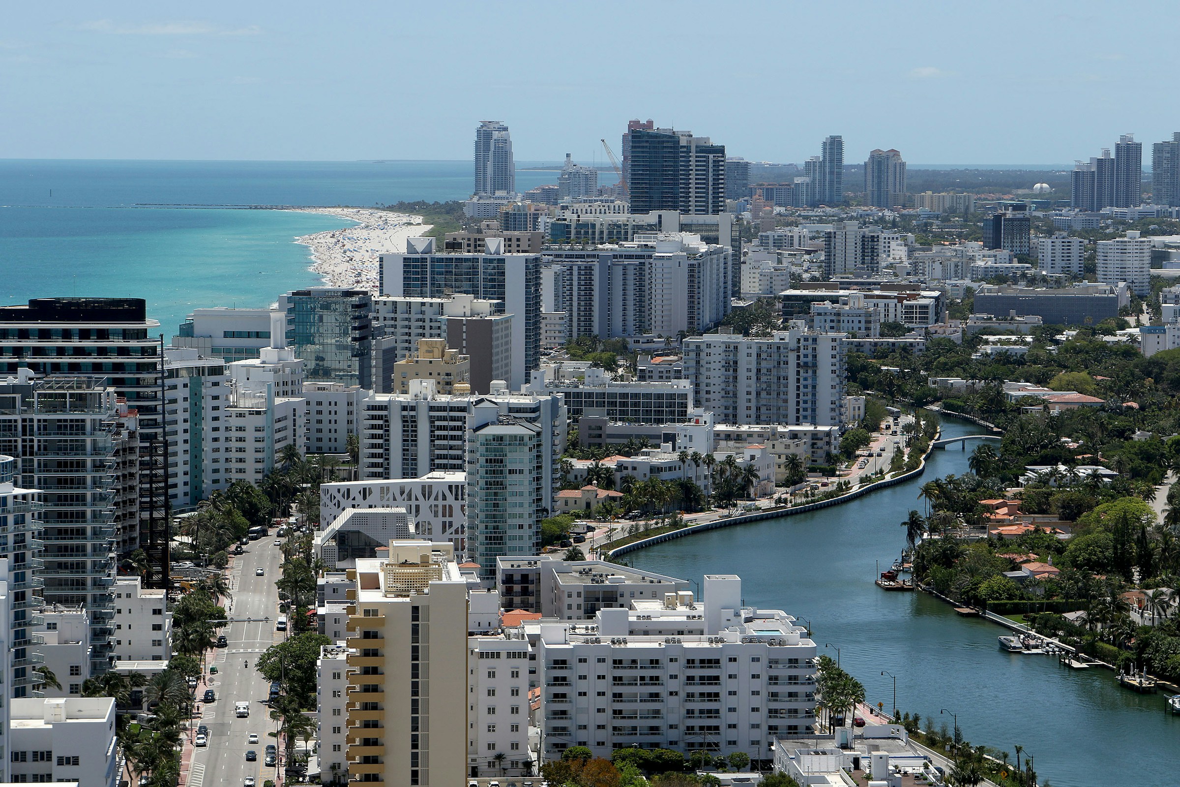 Aerial view of a coastal city with high-rise buildings and a river