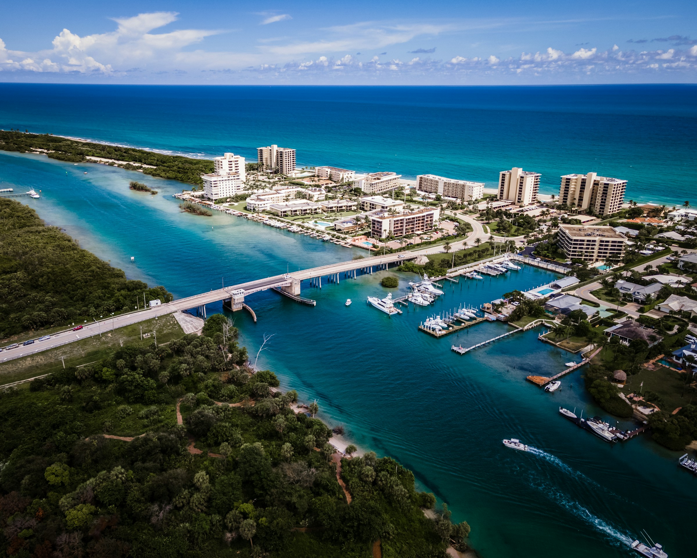 Aerial view of coastal city with bridge, marina, and ocean