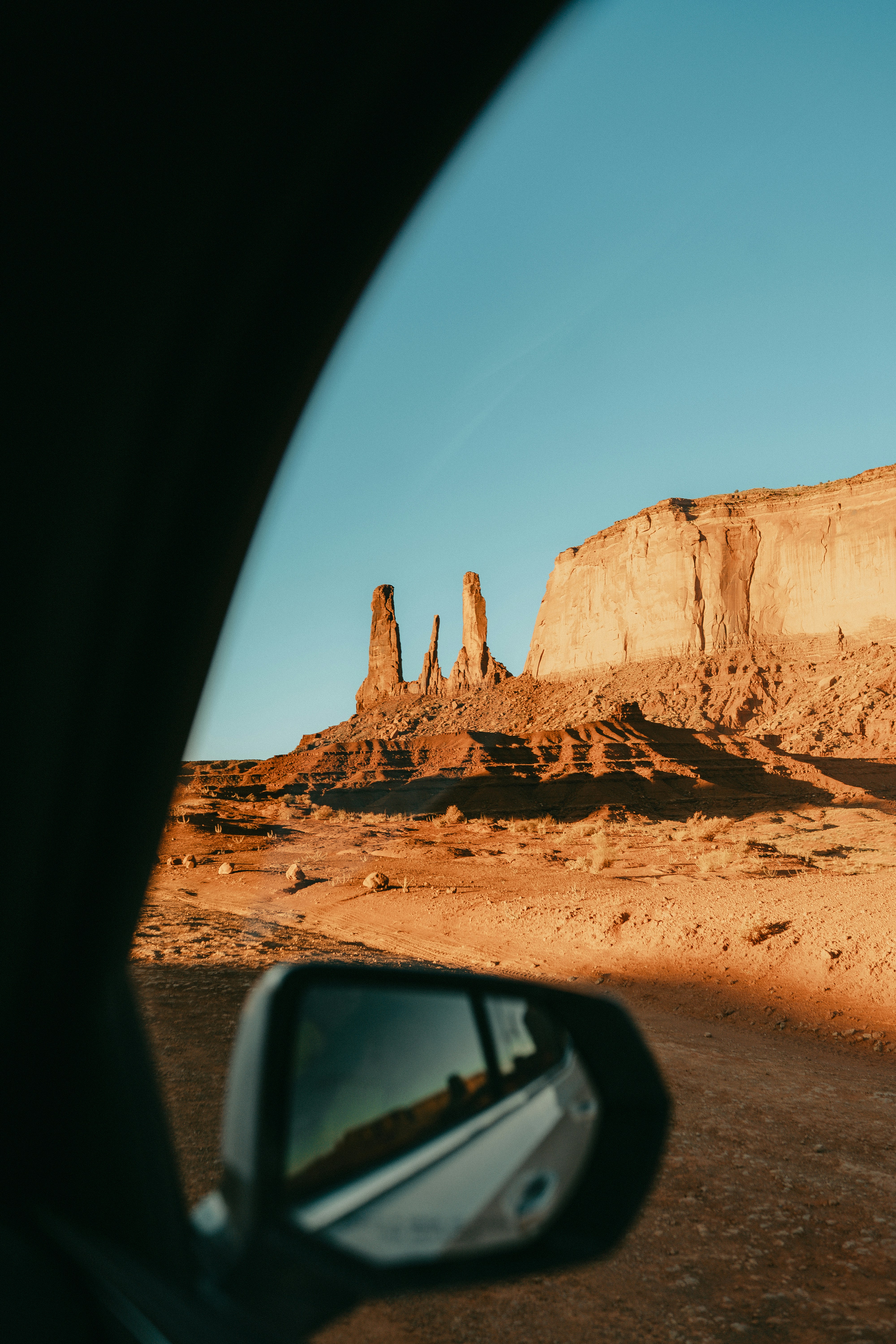 View of desert rock formations through a car window