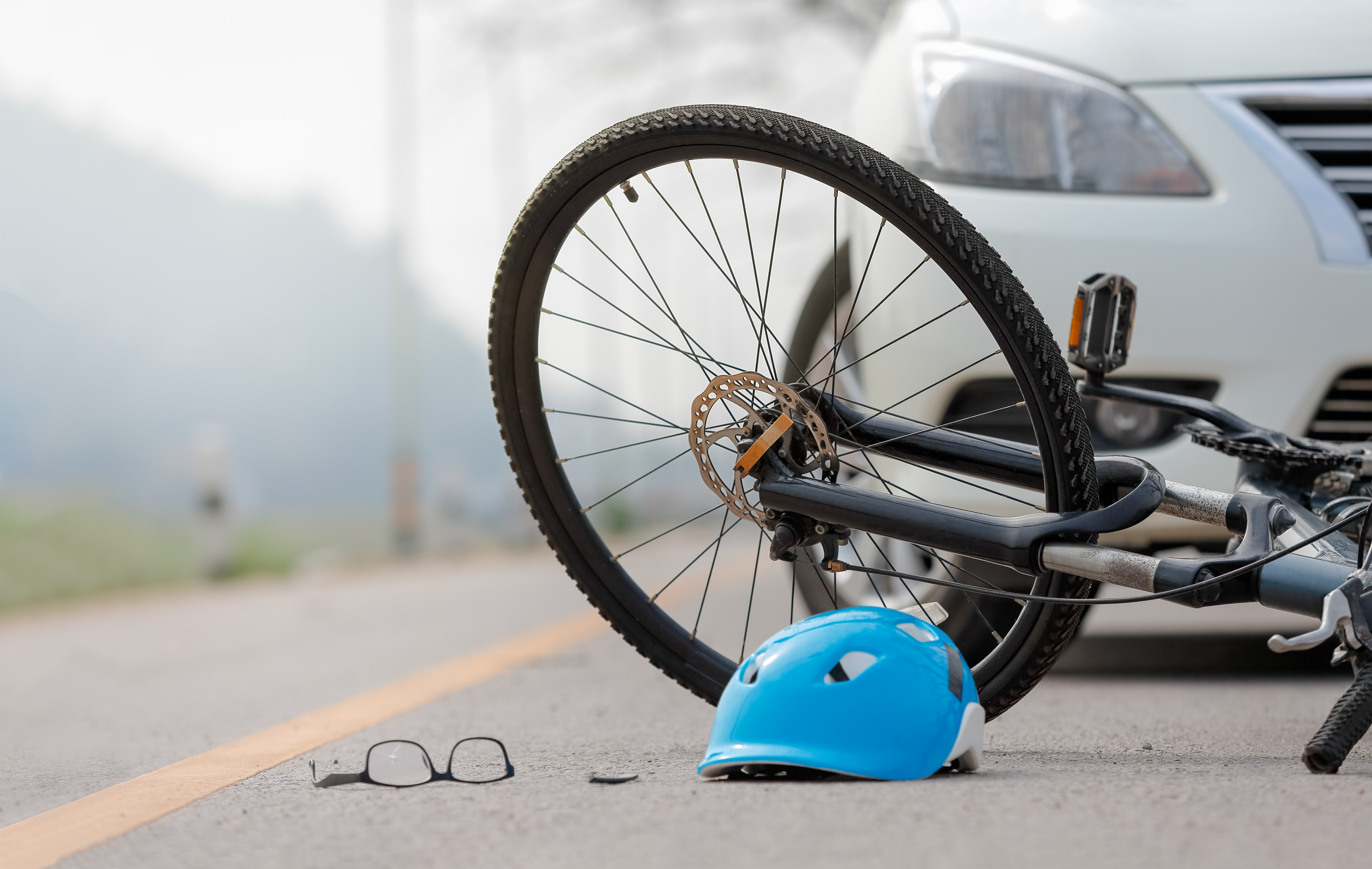 Bicycle and helmet on the road after a collision with a car