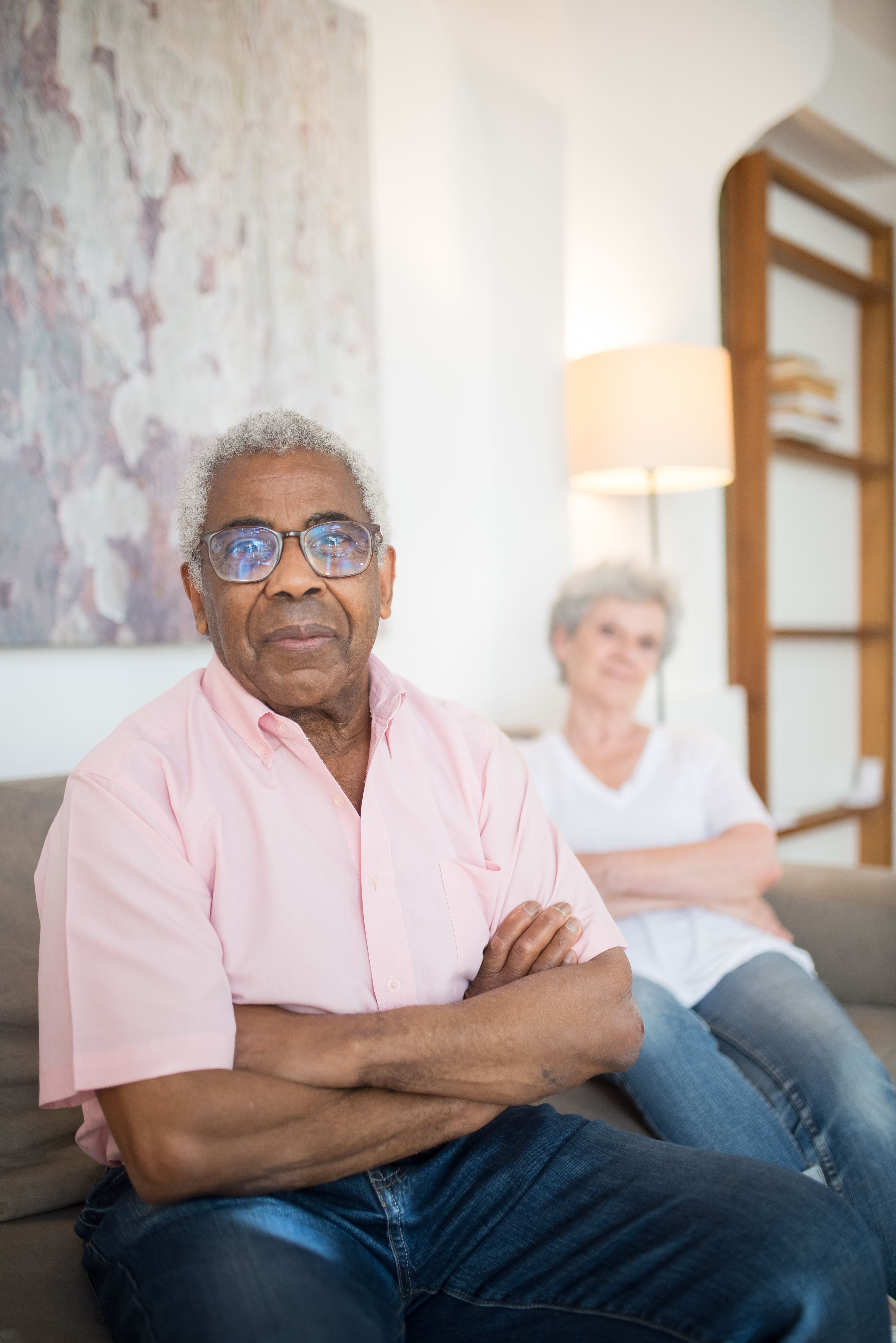Elderly couple sitting on a couch in a living room