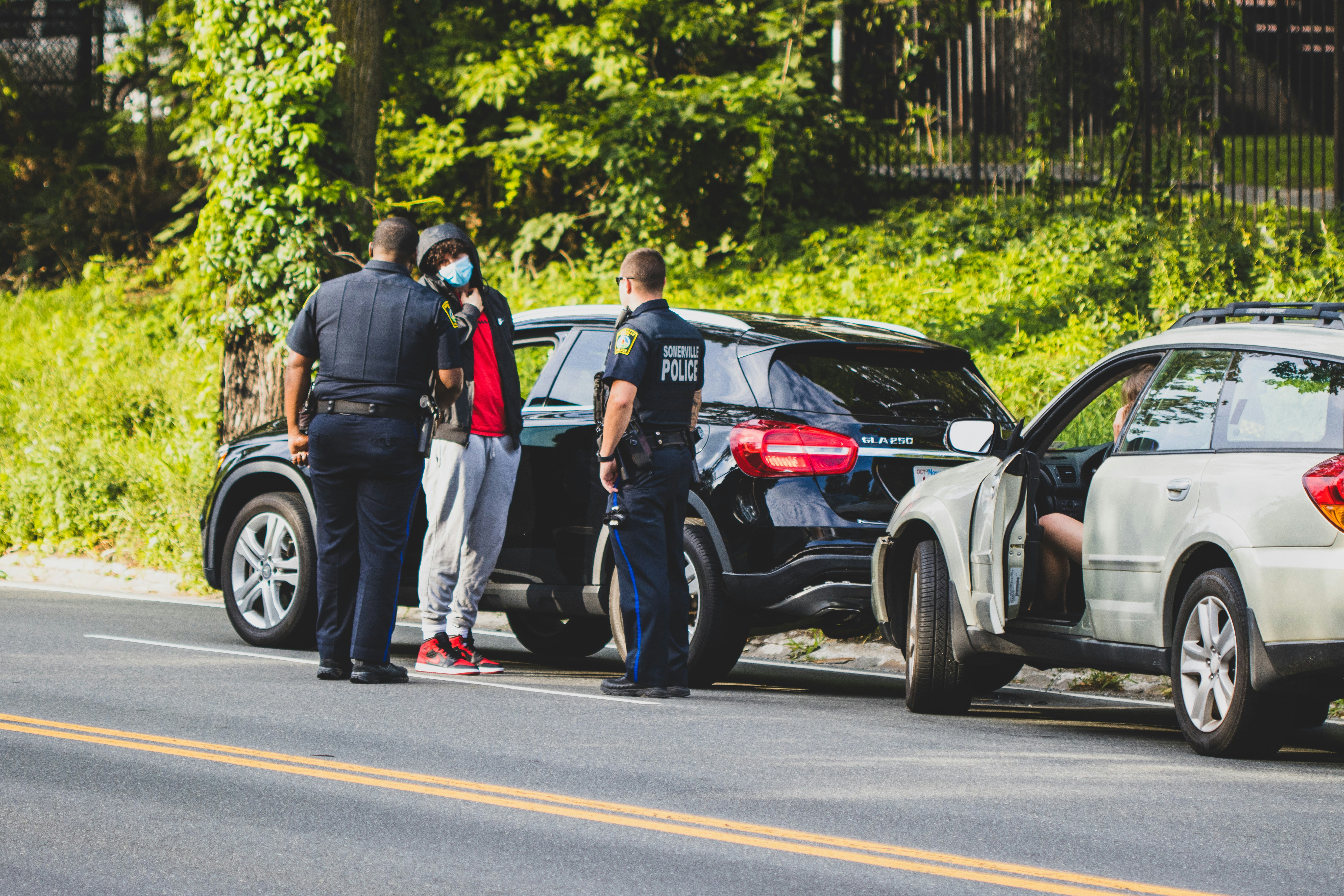 Police officers talking to a driver on the side of the road