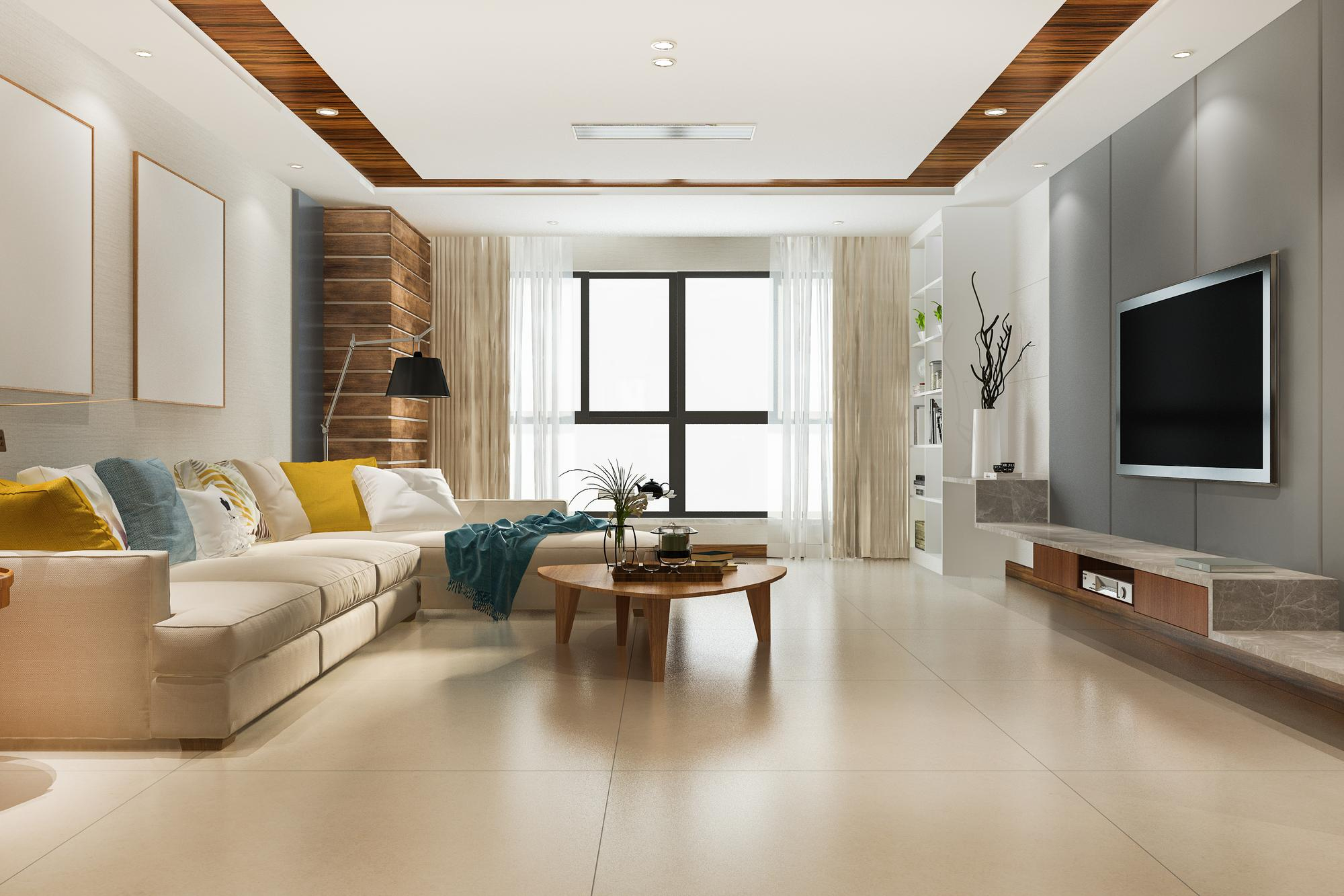 Modern living room with a large sofa, coffee table, and wall-mounted TV