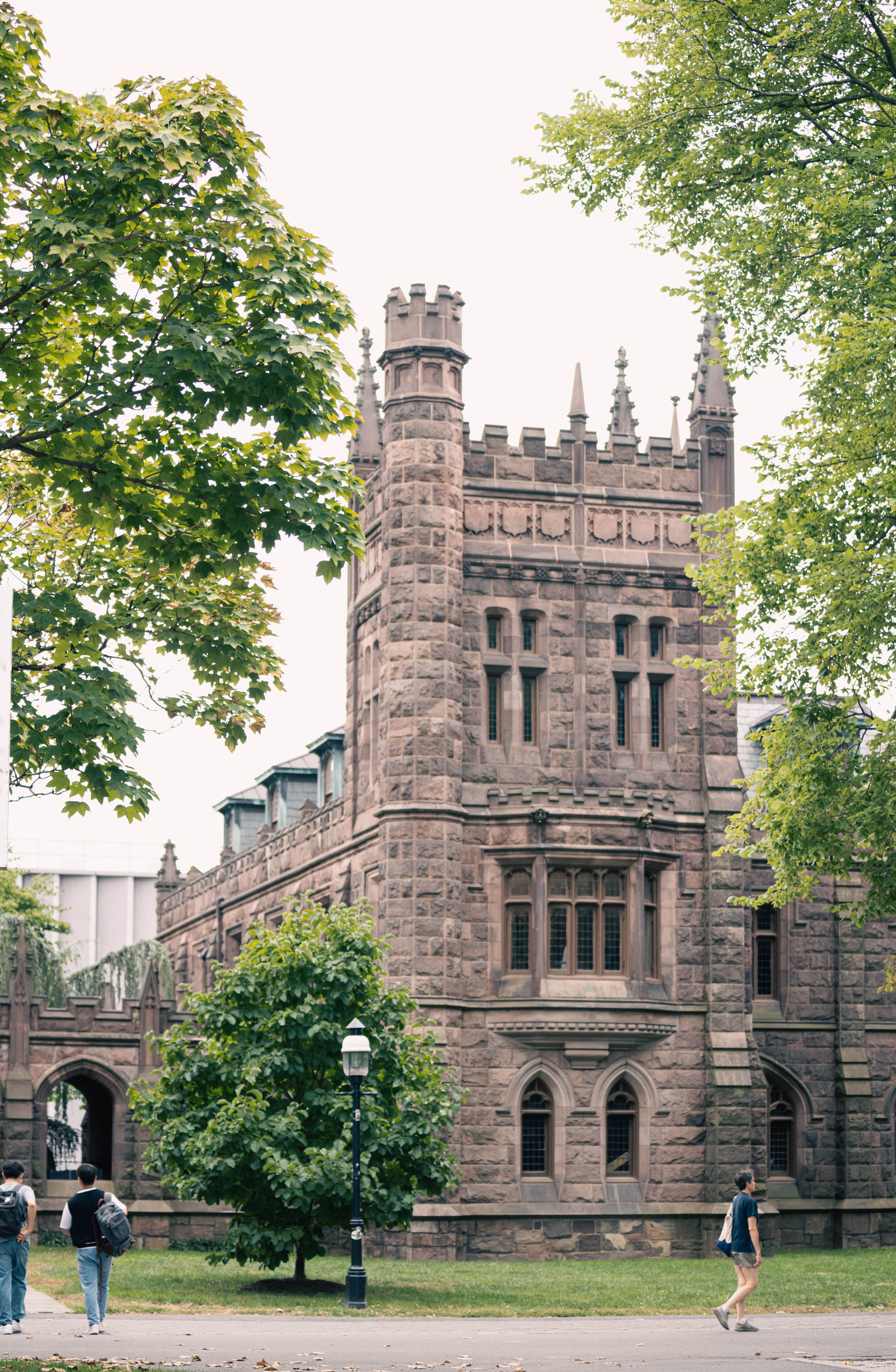 Historic stone building with gothic architecture surrounded by trees