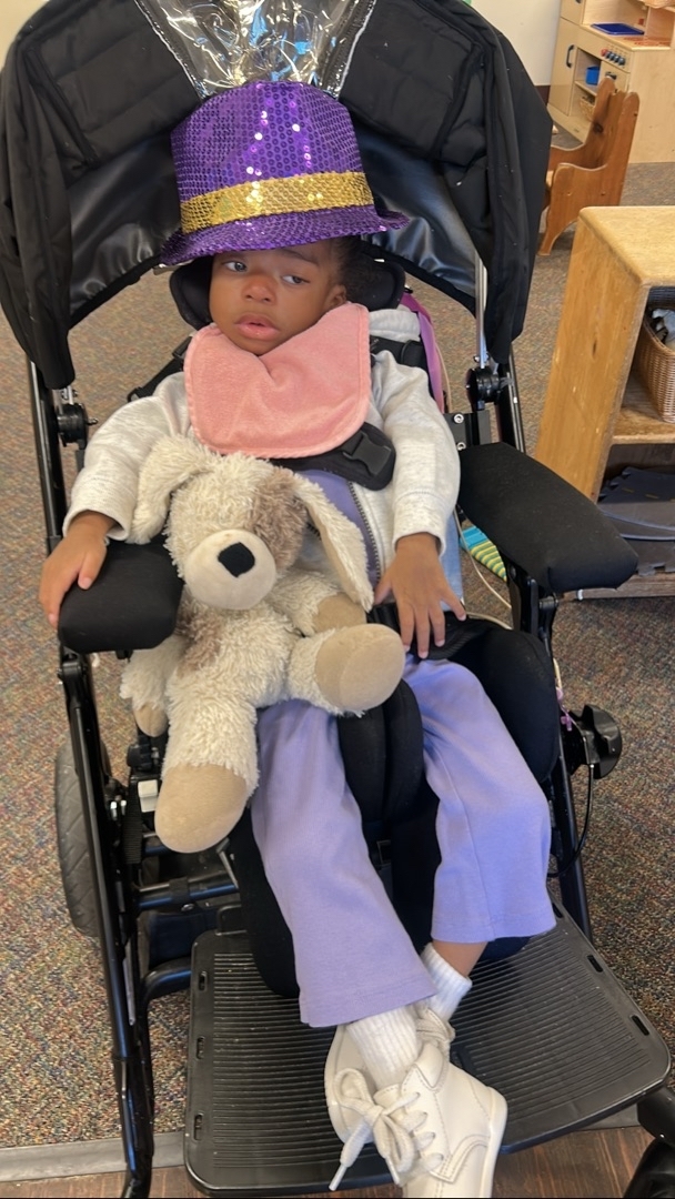 A group of children are sitting on the ground playing with clay.