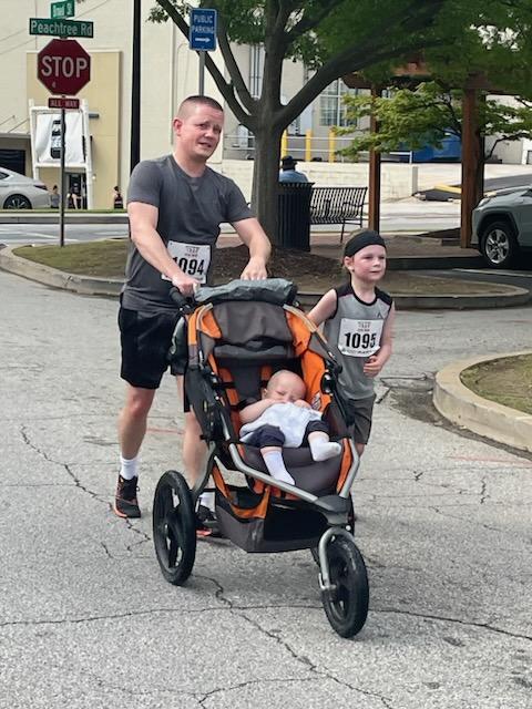 A group of children are sitting on the ground playing with clay.