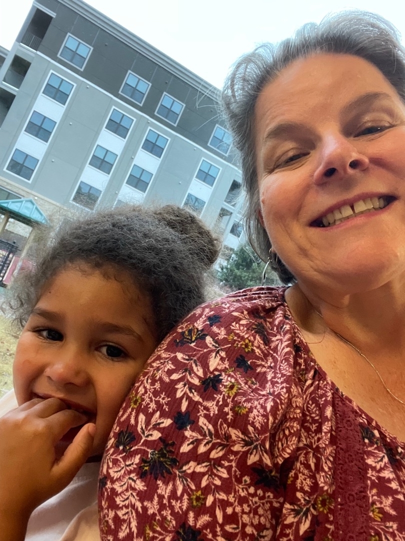 A group of children are sitting on the ground playing with clay.