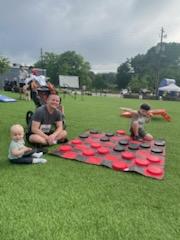 A group of children are sitting on the ground playing with clay.