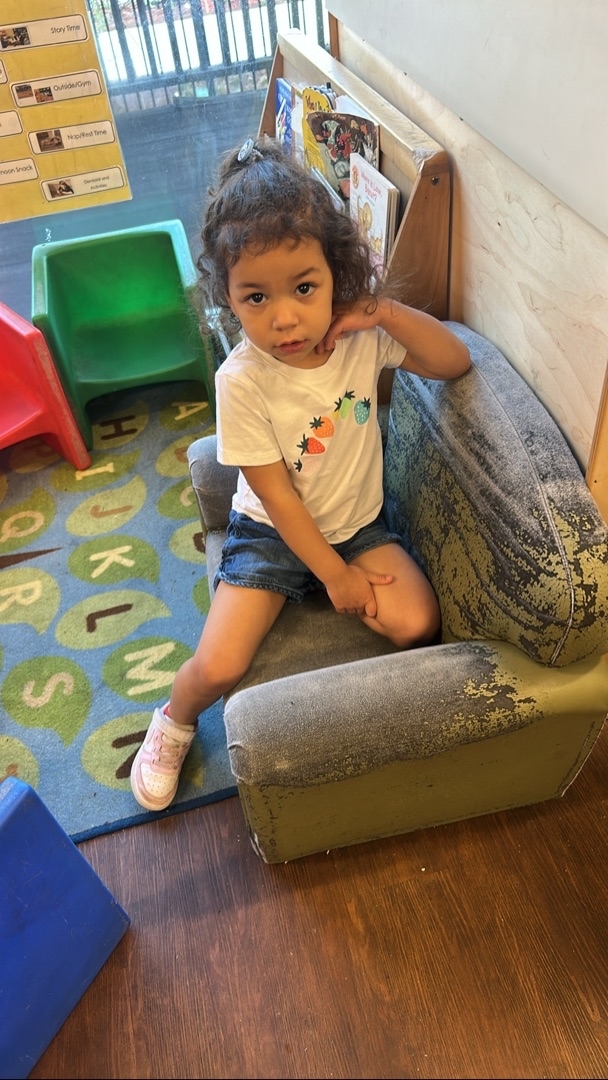 A group of children are sitting on the ground playing with clay.