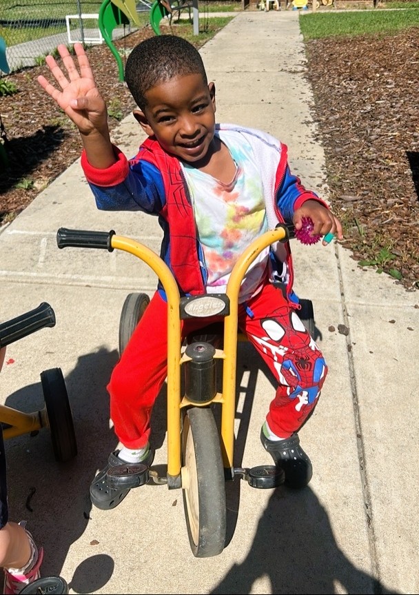 A group of children are sitting on the ground playing with clay.