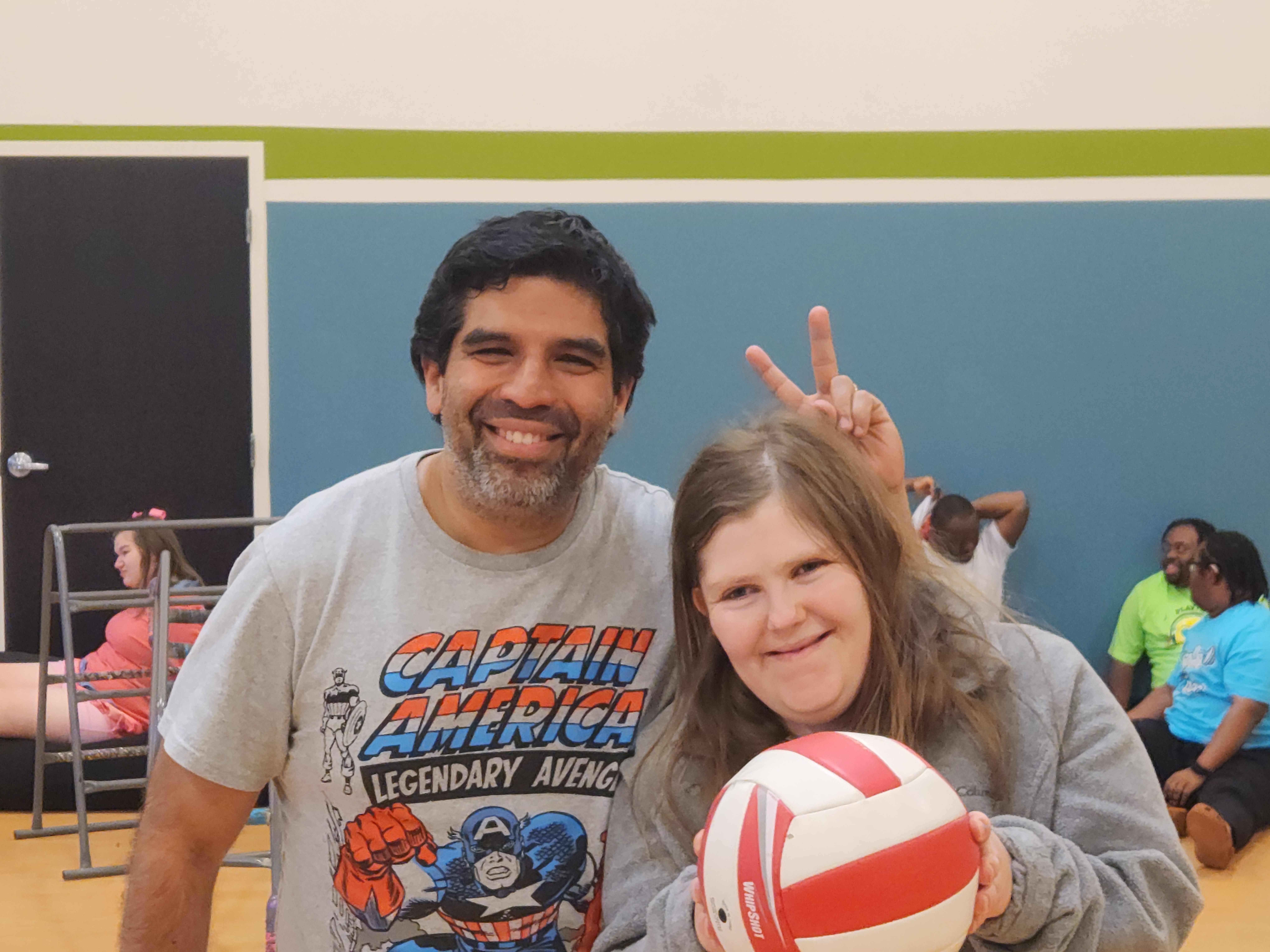 A group of children are sitting on the ground playing with clay.