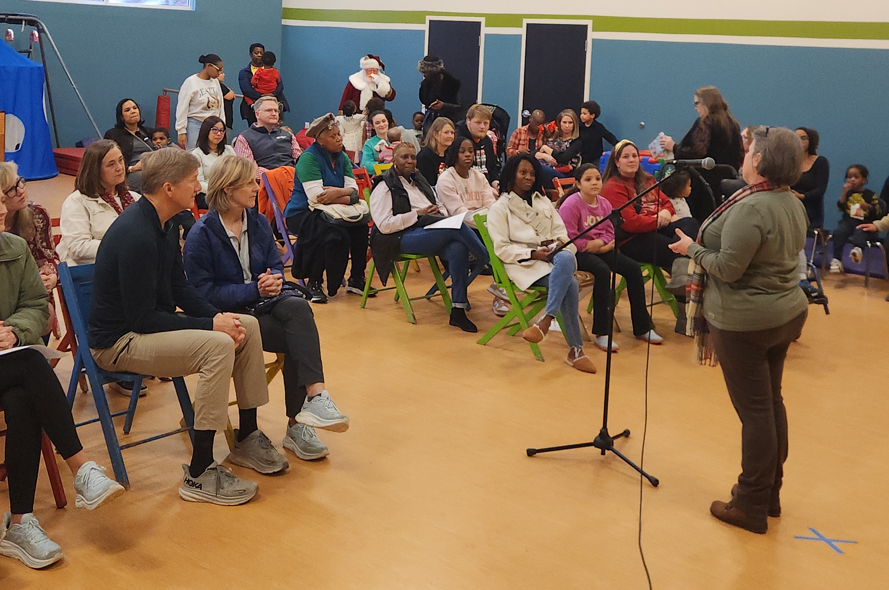 A group of children are sitting on the ground playing with clay.
