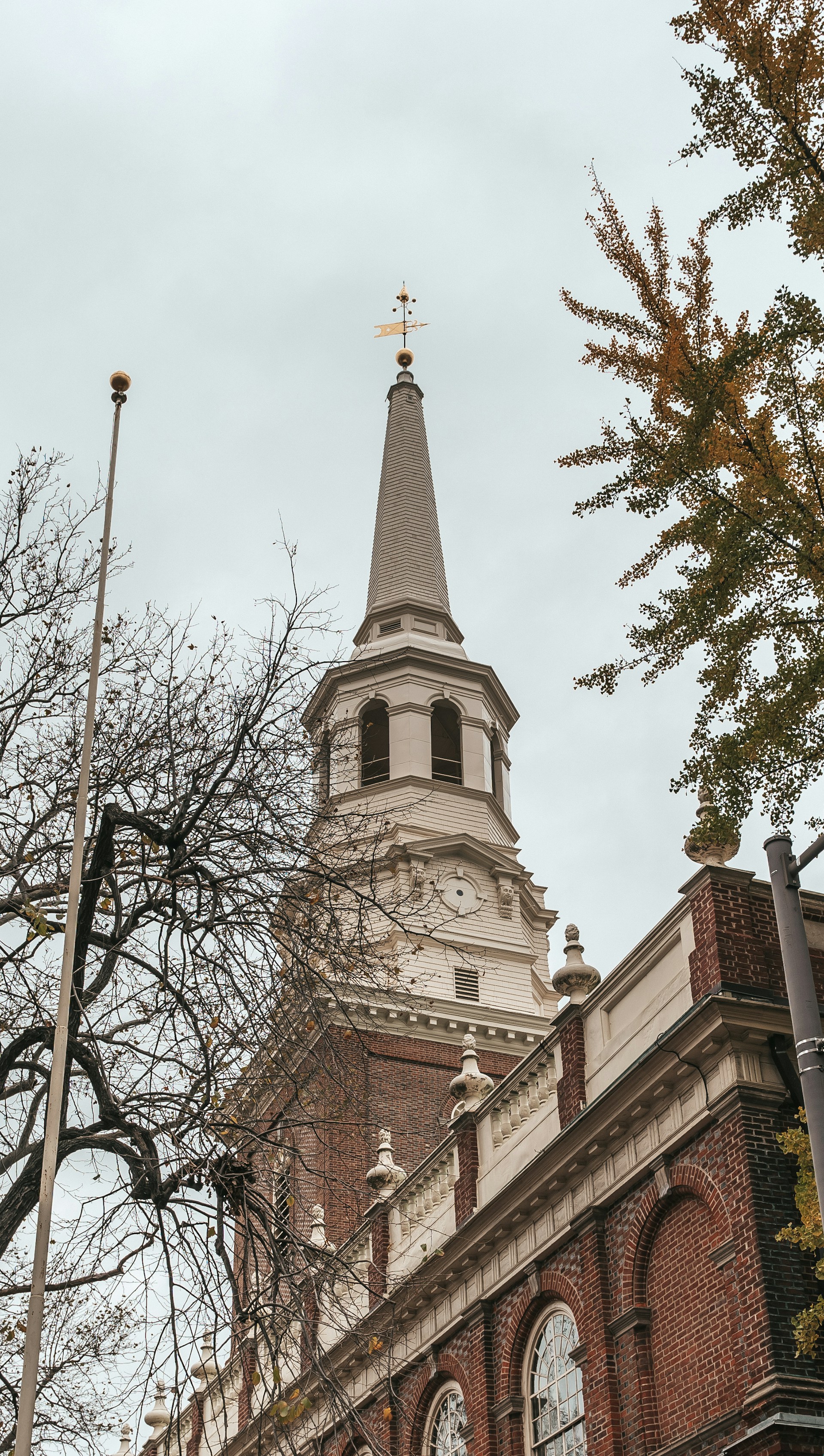 Historic brick church with a tall steeple and clock tower