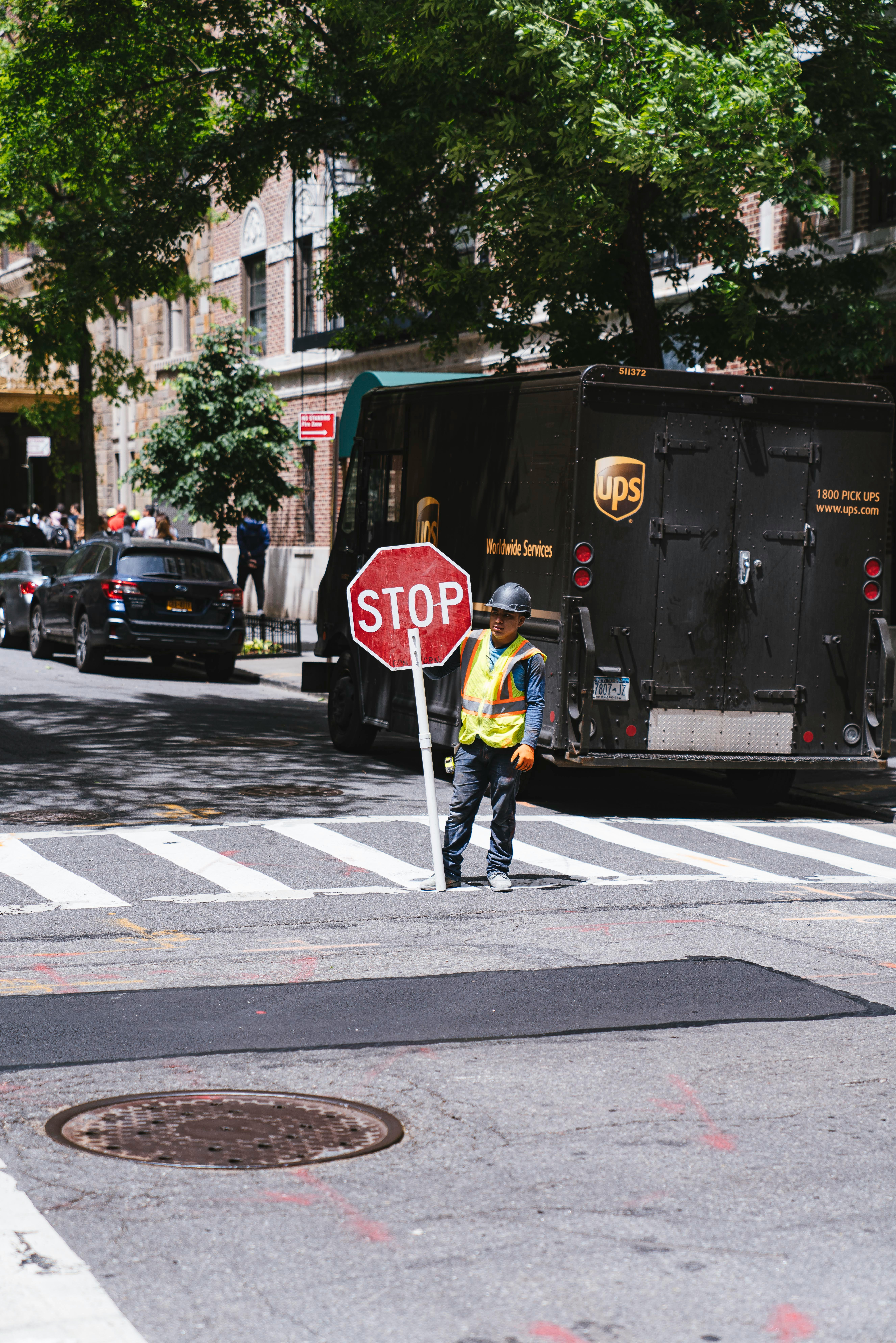 Construction worker holding a stop sign on a city street