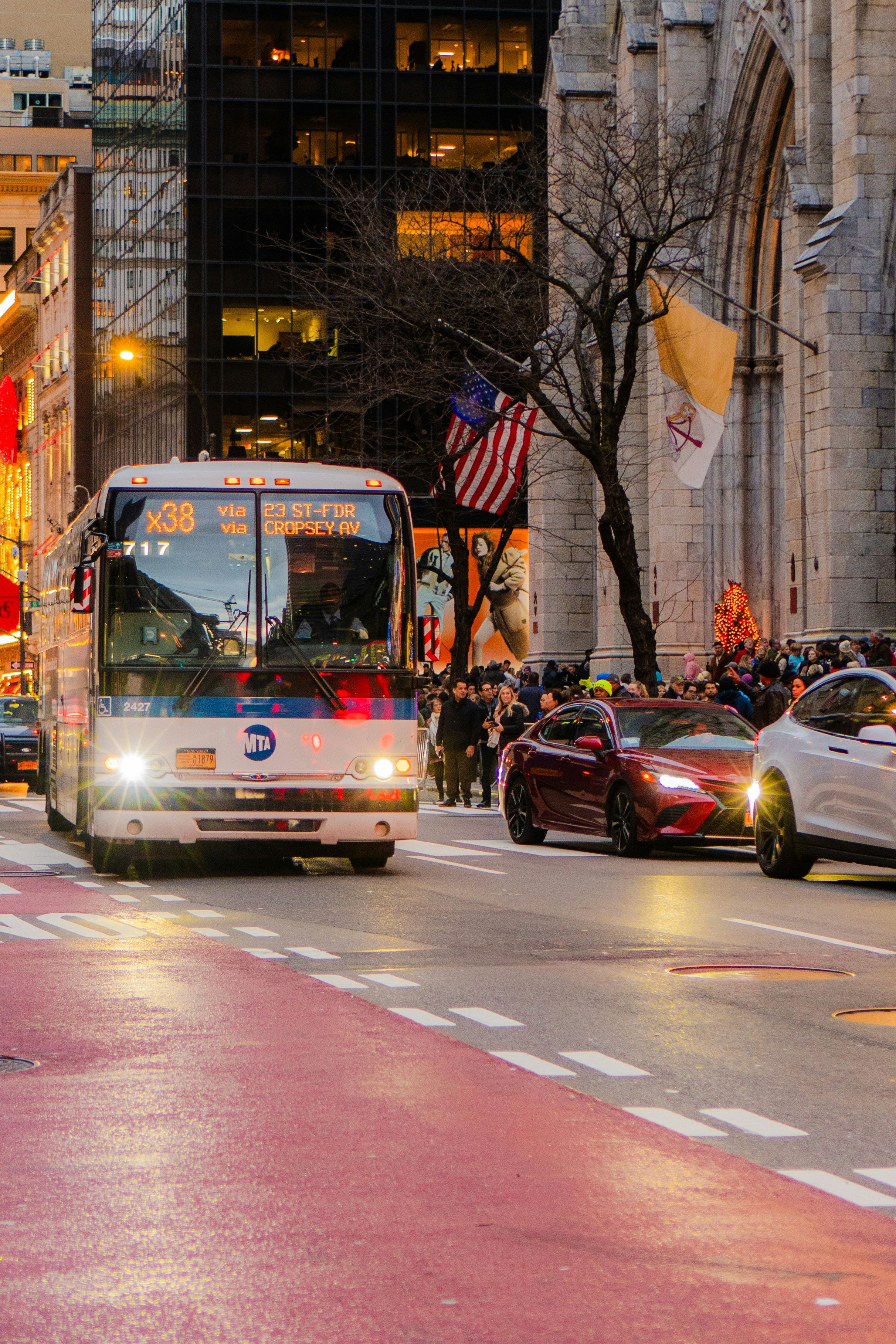 City street with a bus and cars in traffic during the evening