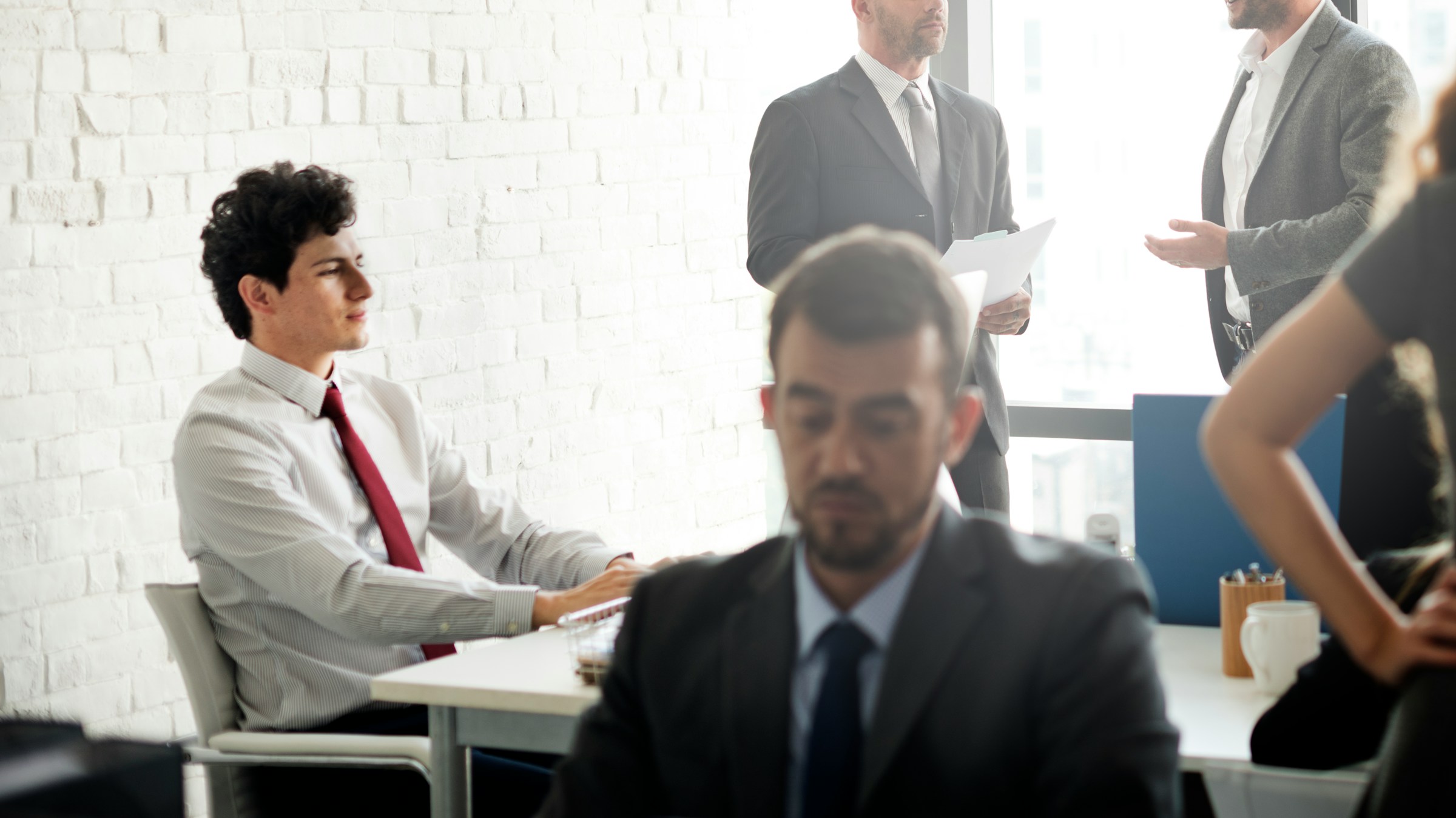 Business professionals in a meeting room discussing work