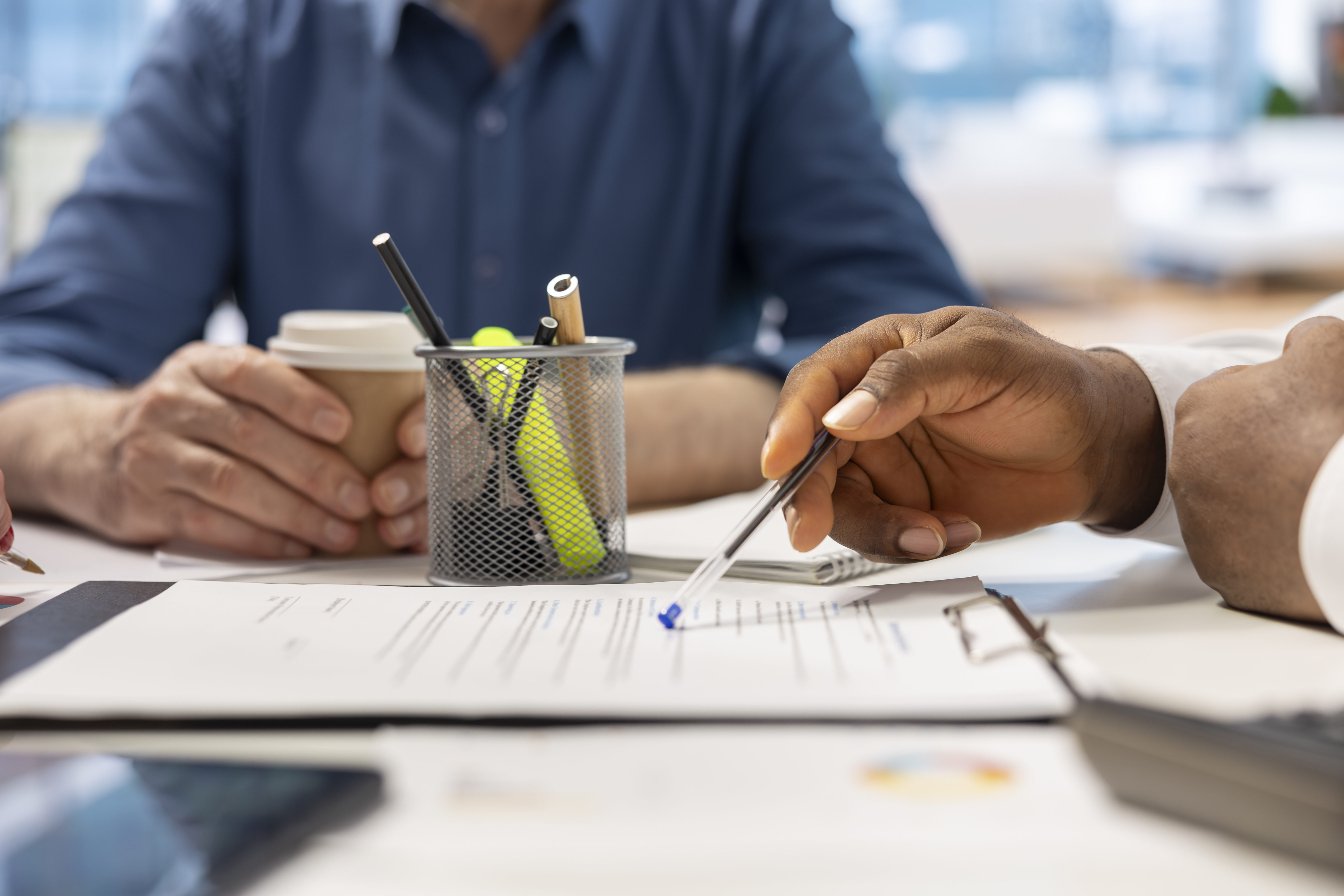 A judge 's gavel is sitting on top of a stack of books on a table.