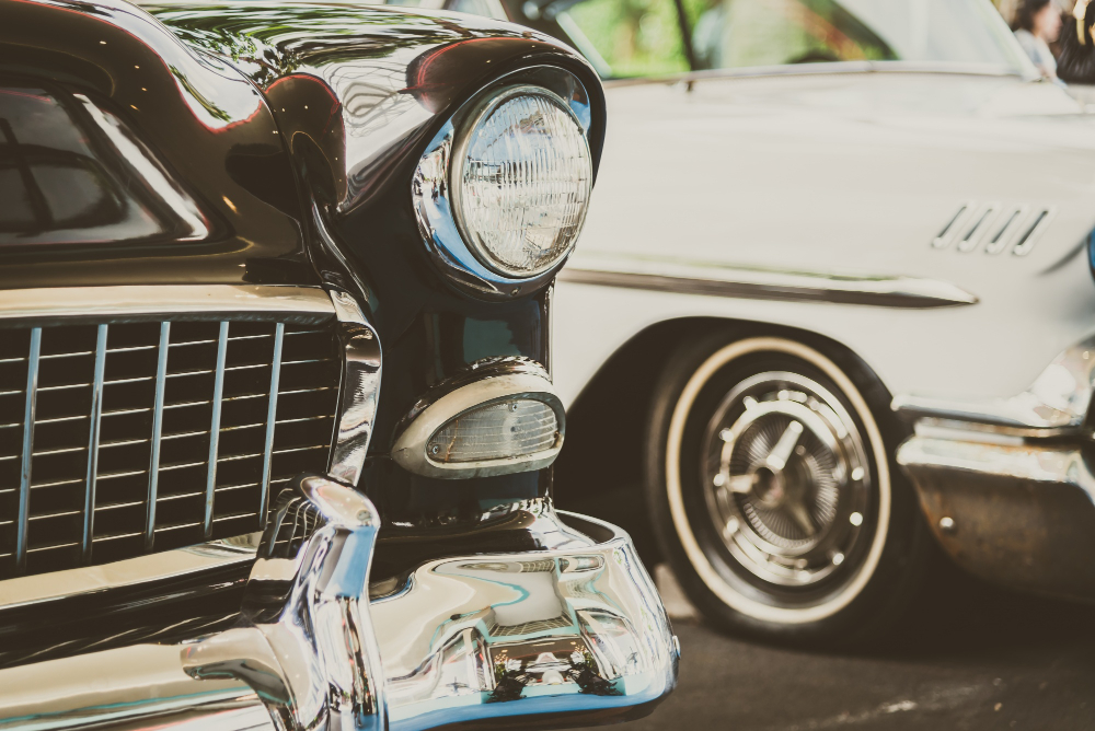 Close-up of two vintage cars with chrome details