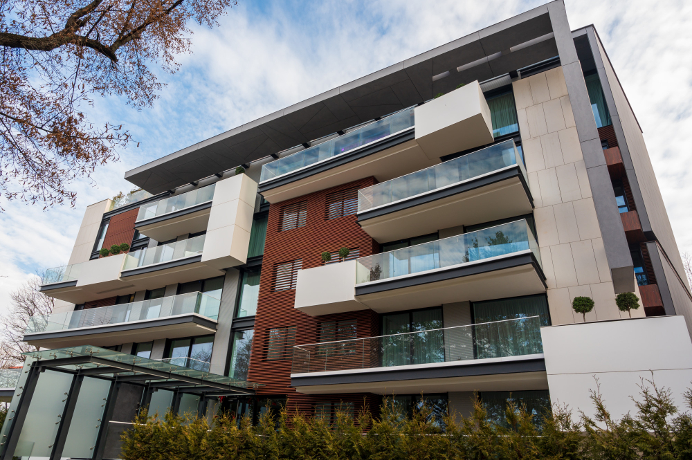 Modern apartment building with large balconies and glass railings