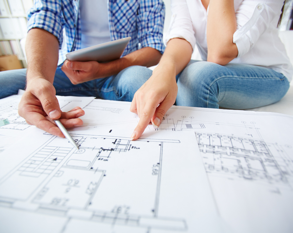 Two people reviewing architectural blueprints with a tablet