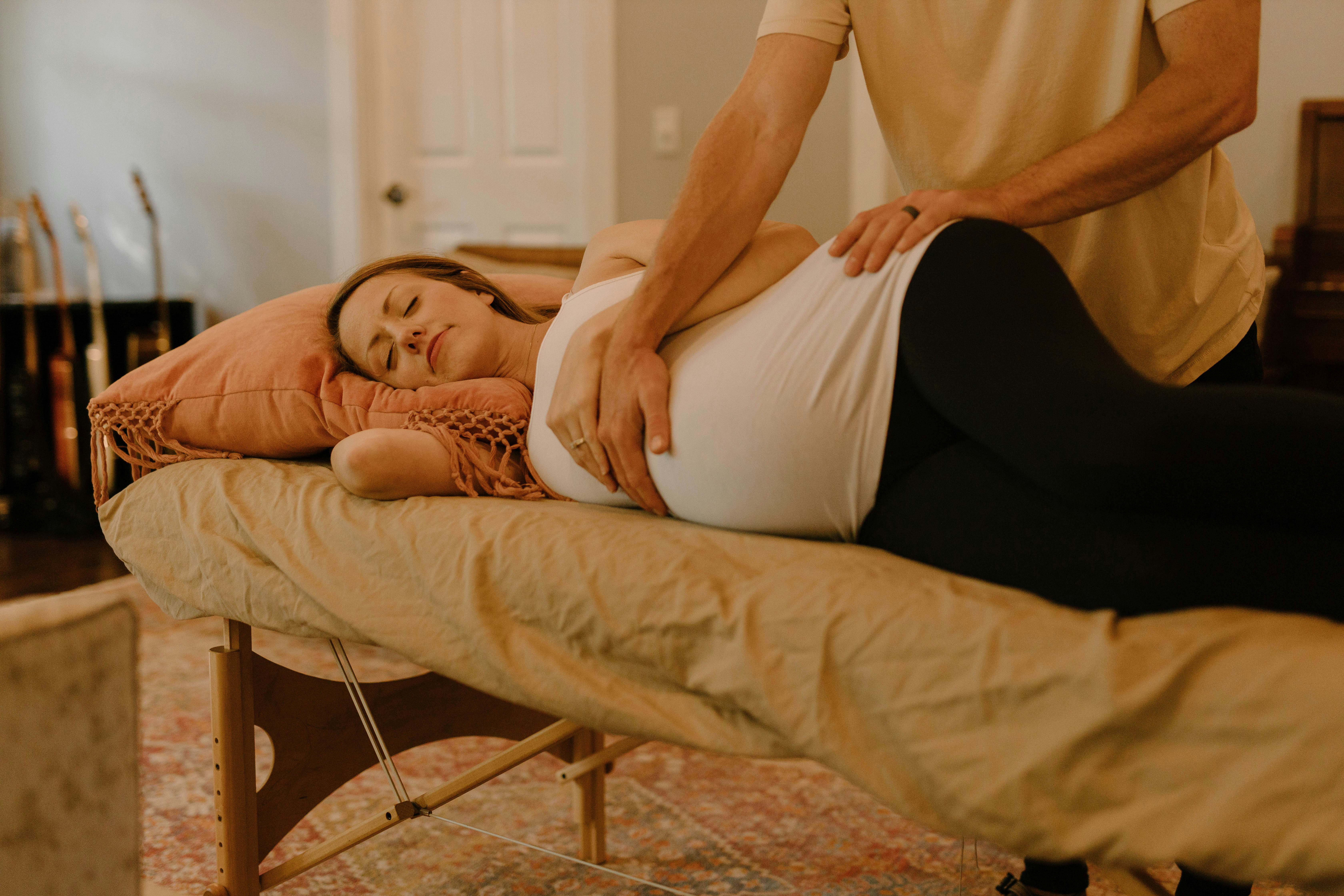 Pregnant woman receiving a massage on a massage table