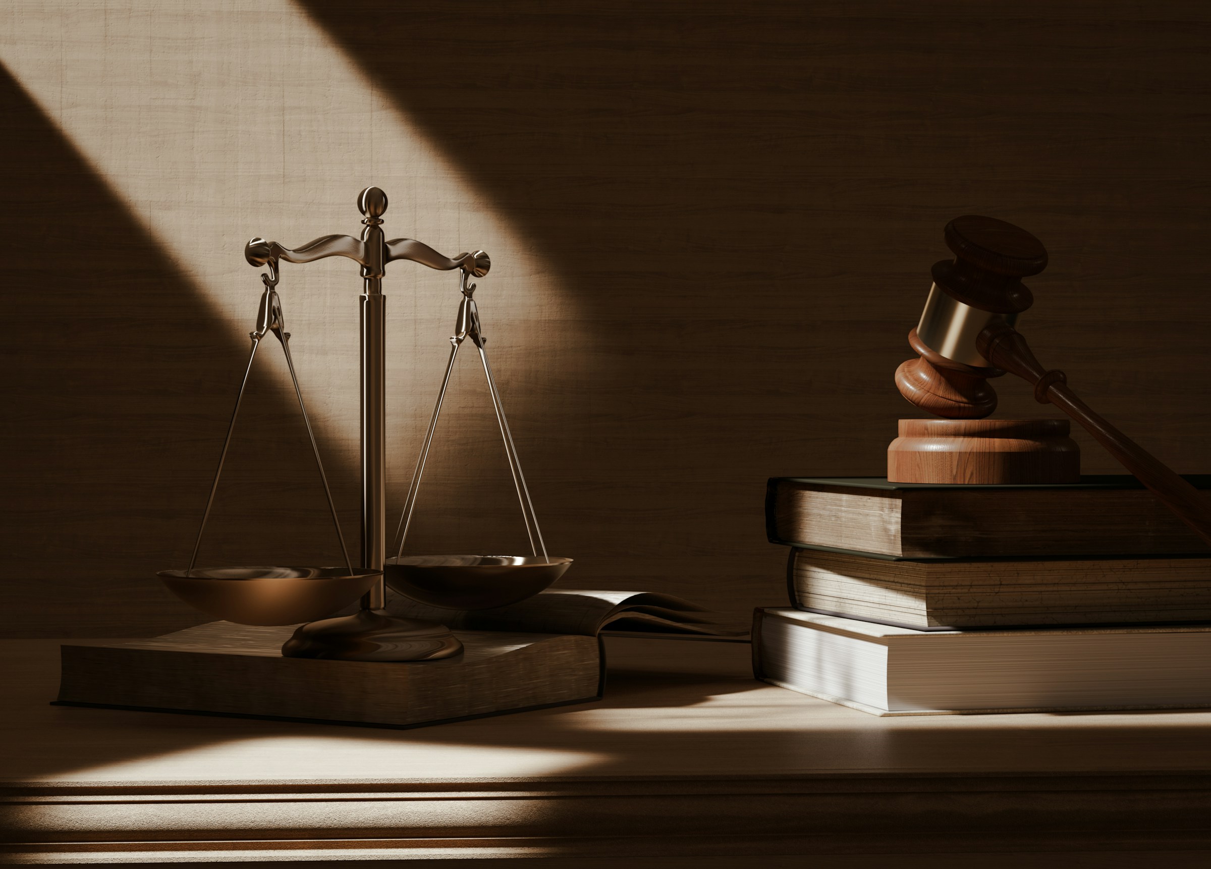 Scales of justice and a gavel on a stack of law books