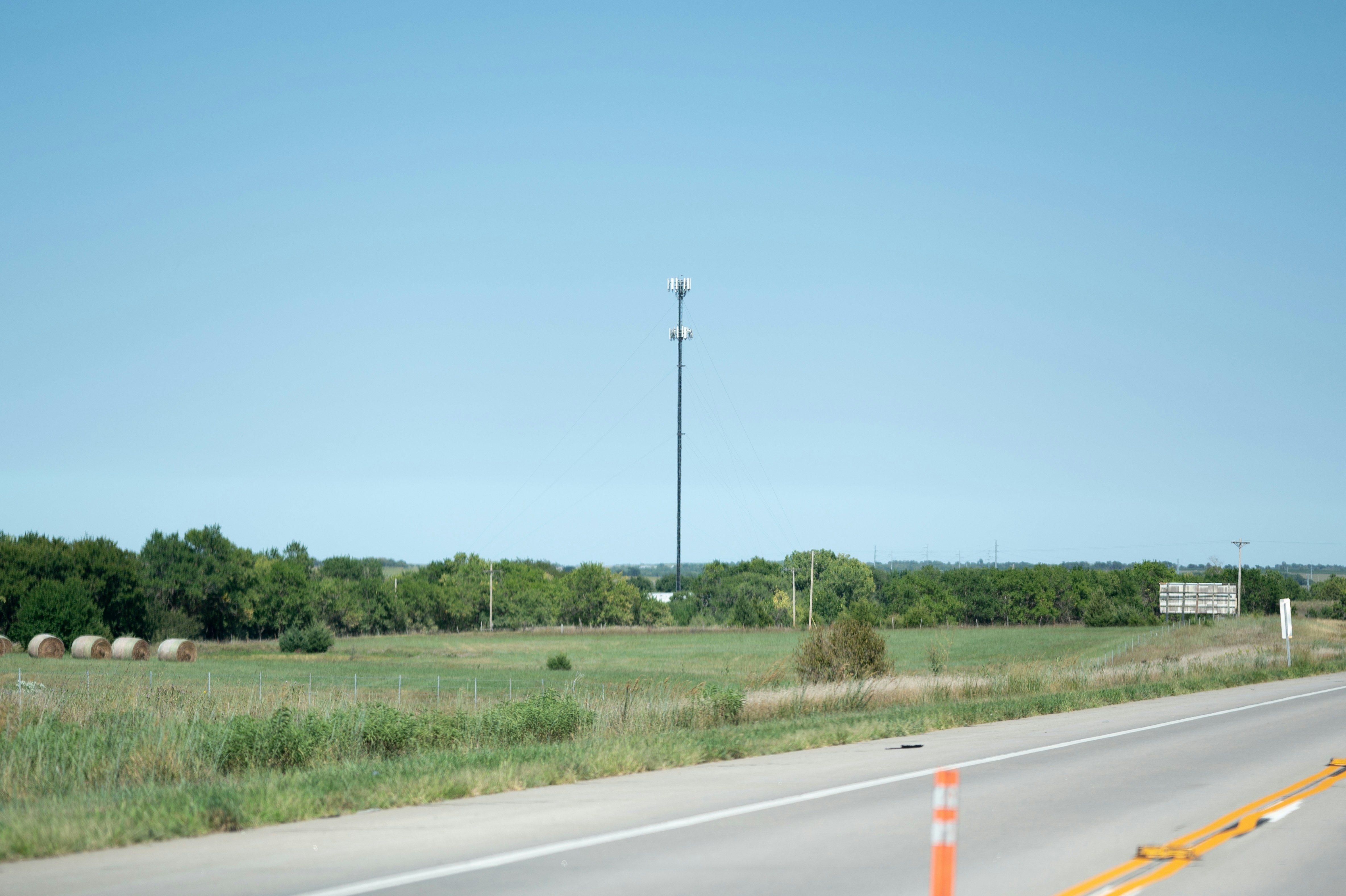 Cell tower in a rural landscape with a clear sky