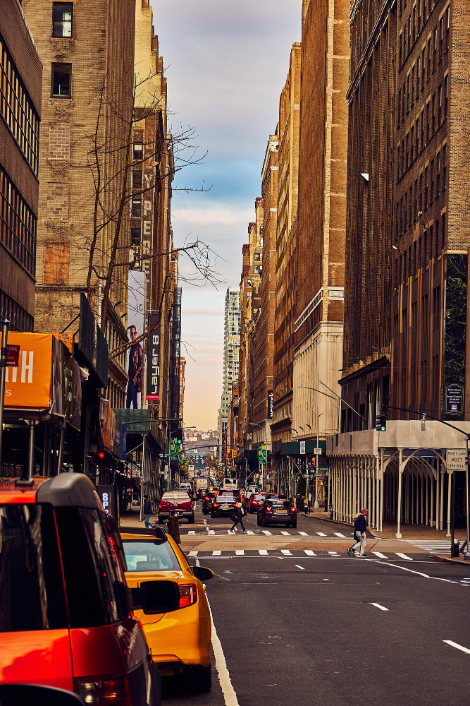 Busy urban street with cars and tall buildings in New York City