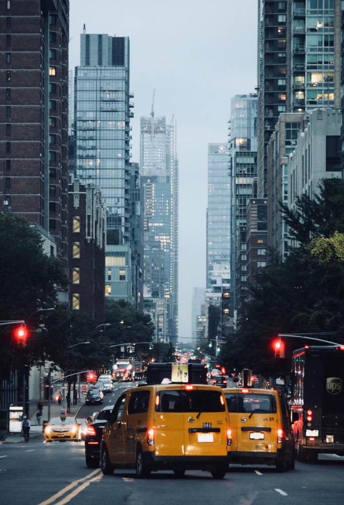 Busy city street in New York with yellow taxis and tall buildings