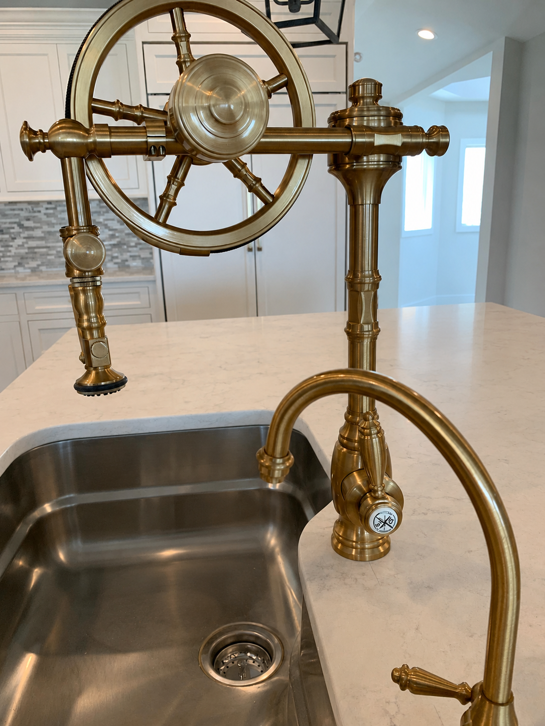 Vintage-style brass kitchen faucet with a unique wheel handle design