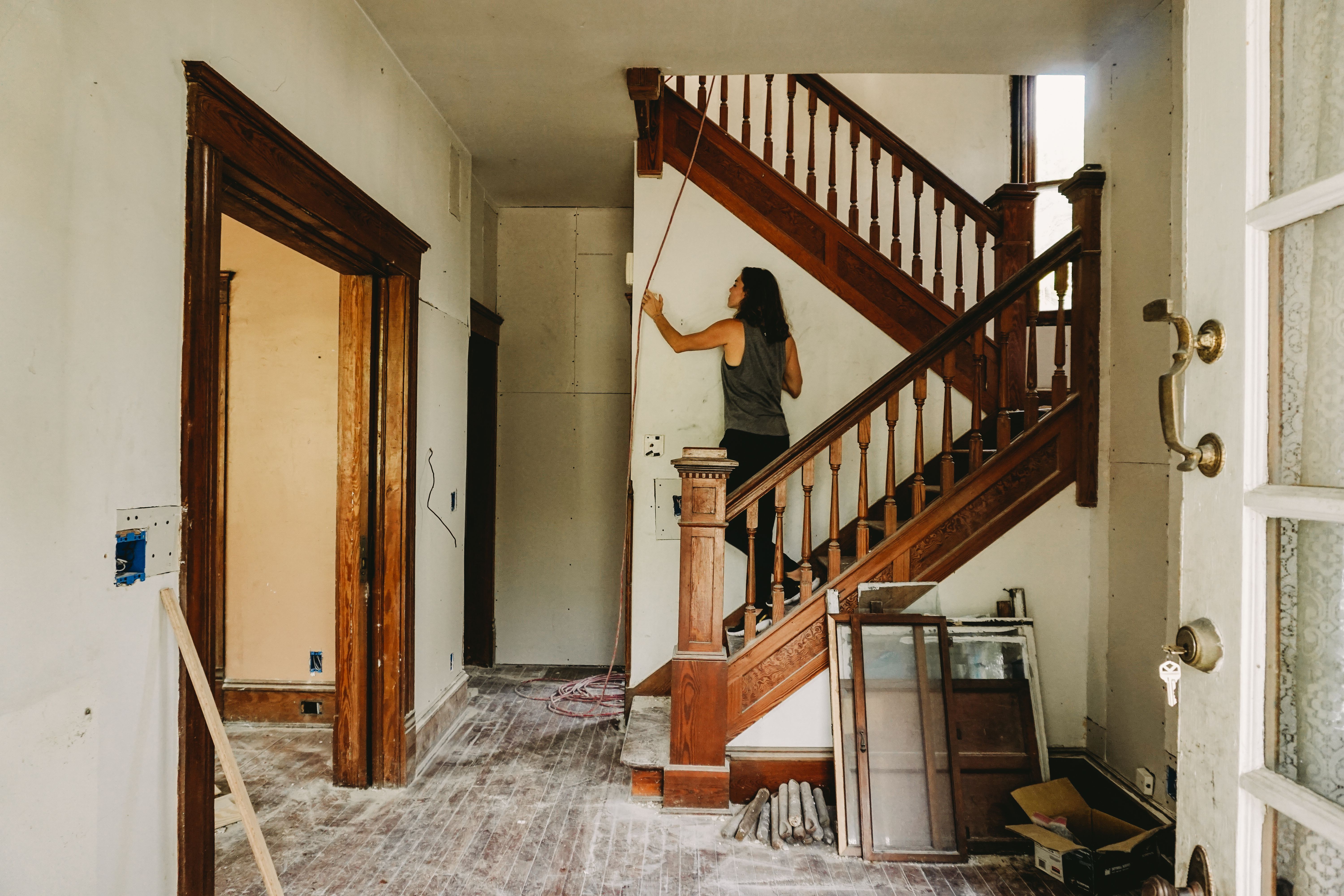 Person working on staircase in a house under renovation